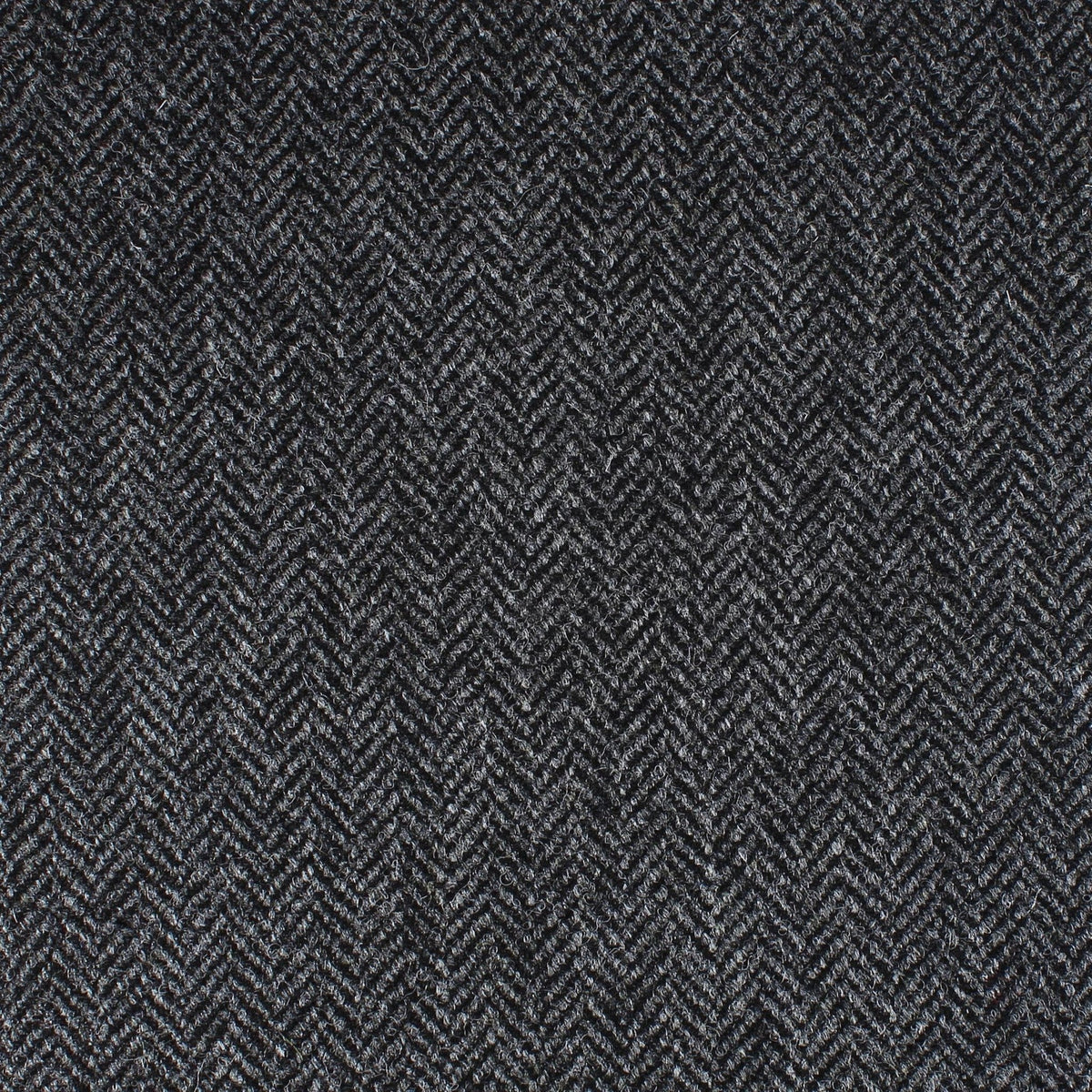 Field Tweed 153 by Lovat Mill features dark grey fabric with a tightly woven herringbone pattern—classic Scottish tweed ideal for stylish country clothing.