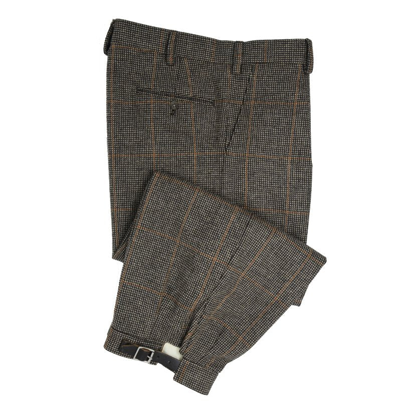 Campbell’s of Beauly Plus Fours in brown tweed with a fine houndstooth pattern, an orange windowpane check, and a buckled strap at the knee.