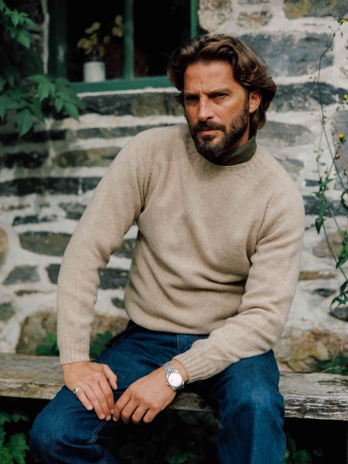 A bearded man wears a beige Campbell’s of Beauly Shetland Jumper over an olive-green shirt.