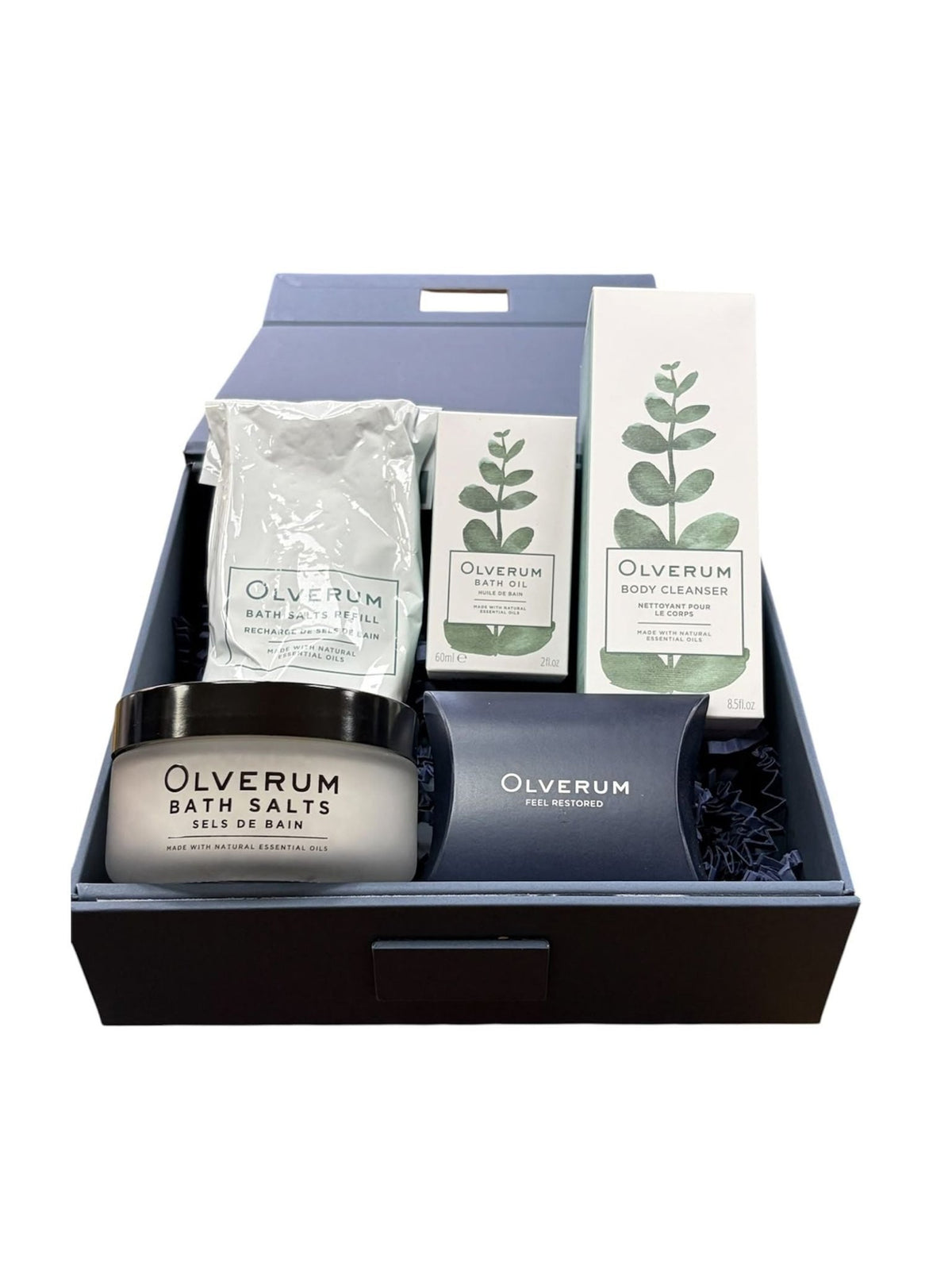 An Olverum Signature Collection gift box containing a jar of bath salts, a bath salts refill pouch, a bottle of bath oil, a bottle of body cleanser, and a small gift box.