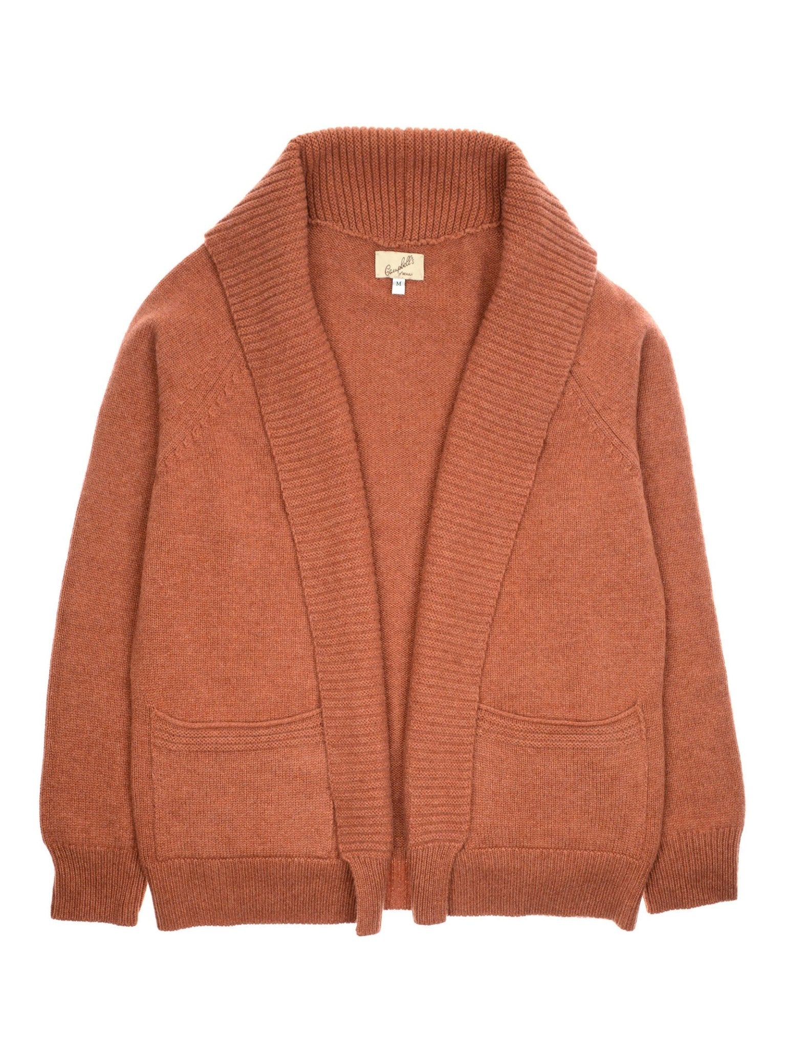 A rust-colored Cashmere Shawl Cardigan by Campbell’s of Beauly, featuring an open front, long sleeves, ribbed collar and edges, and two front pockets, is laid flat on a white background.