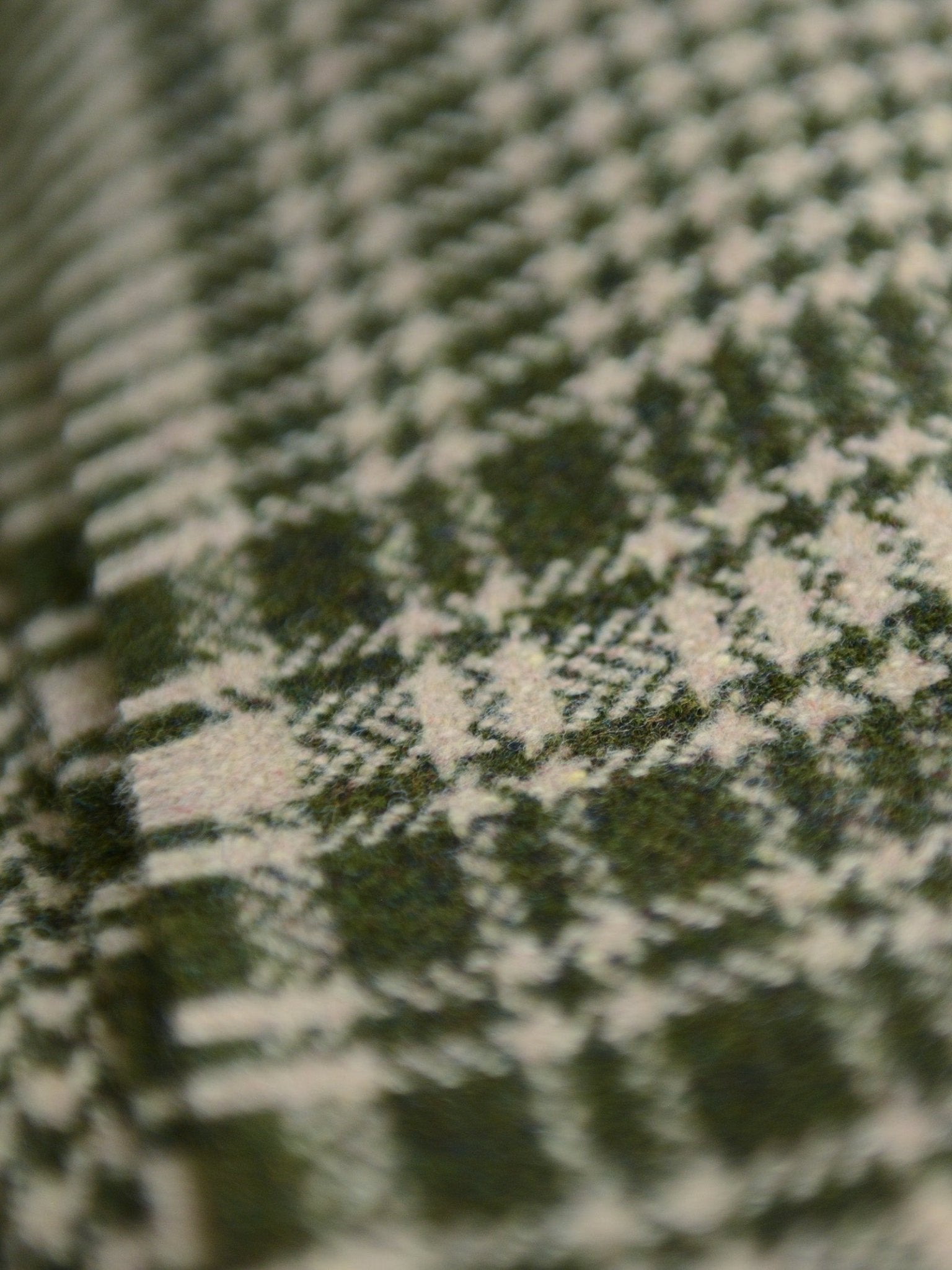 Close-up of the Crofters Blanket by Campbell's of Beauly, featuring green and white plaid. The detailed woven pattern and visible threads highlight its classic country style.