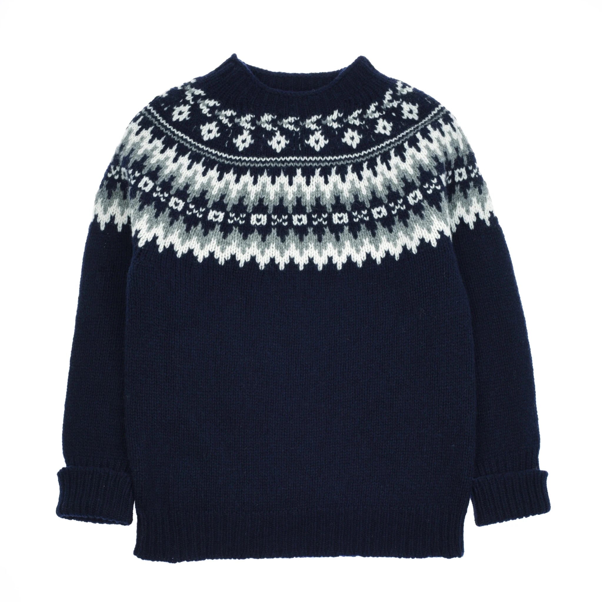 The Auld Stock Chunky Fairisle Jumper by Campbell's of Beauly is a dark blue knit featuring a white and light gray Nordic pattern across the chest and shoulders, with ribbed cuffs and hem—a classic winter essential.