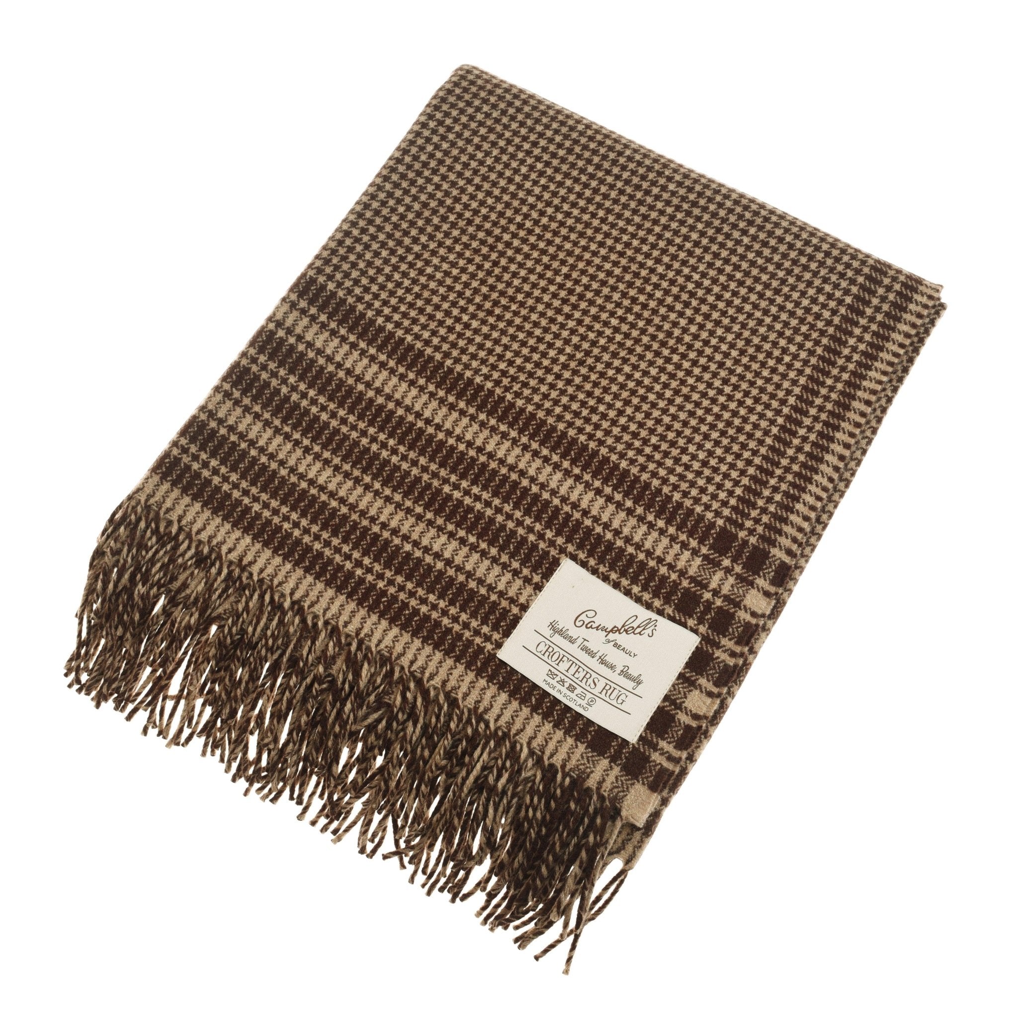 The Campbells of Beauly Crofters Blanket in brown features a houndstooth pattern, fringed edges, and a white label—ideal for introducing classic country style to your home.