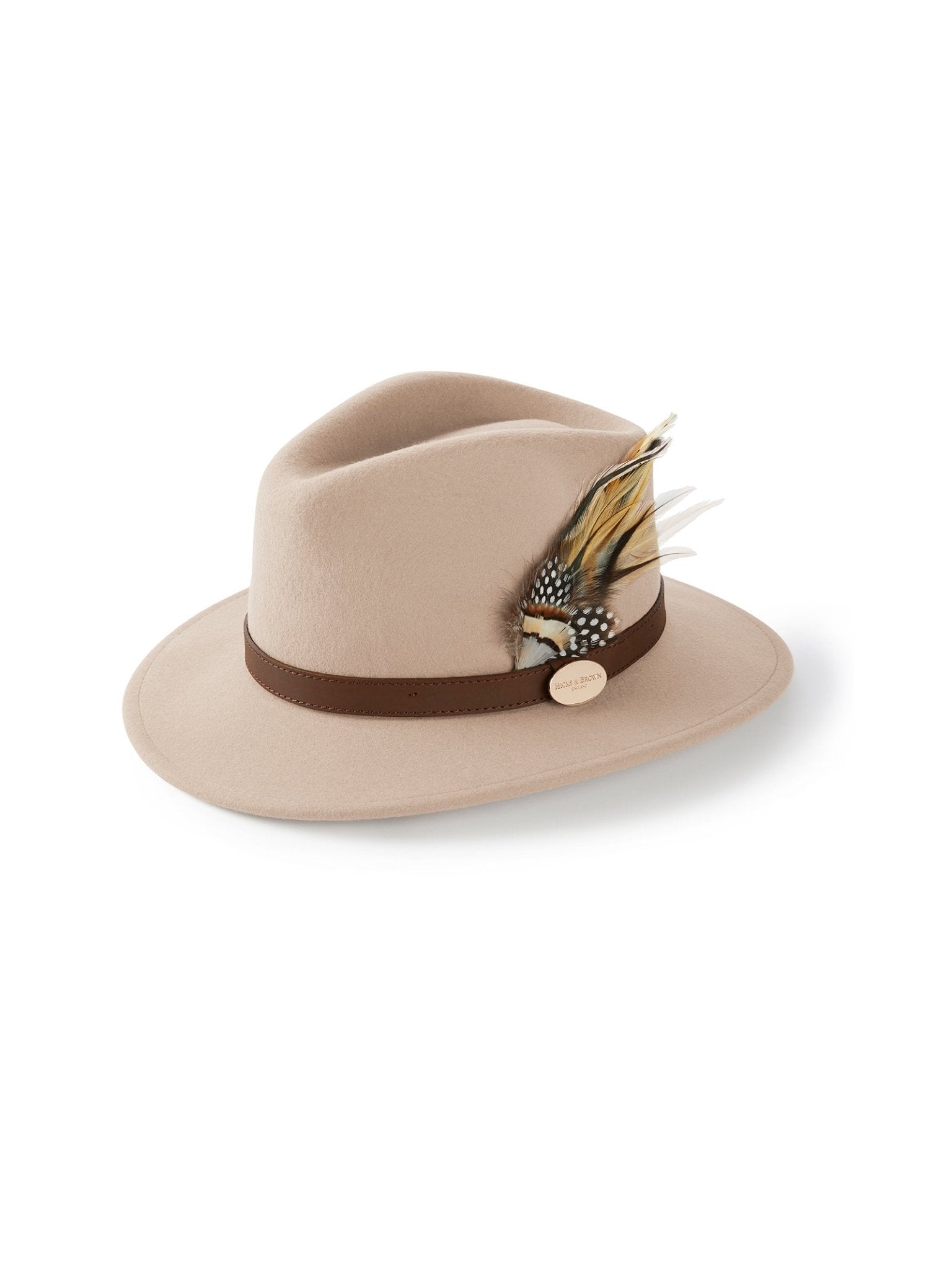 The Hicks & Brown Gamebird Fedora in Pebble is crafted from wool felt, featuring a brown band with a feather wrap, colorful feather cluster, and a small round gold emblem on the side.
