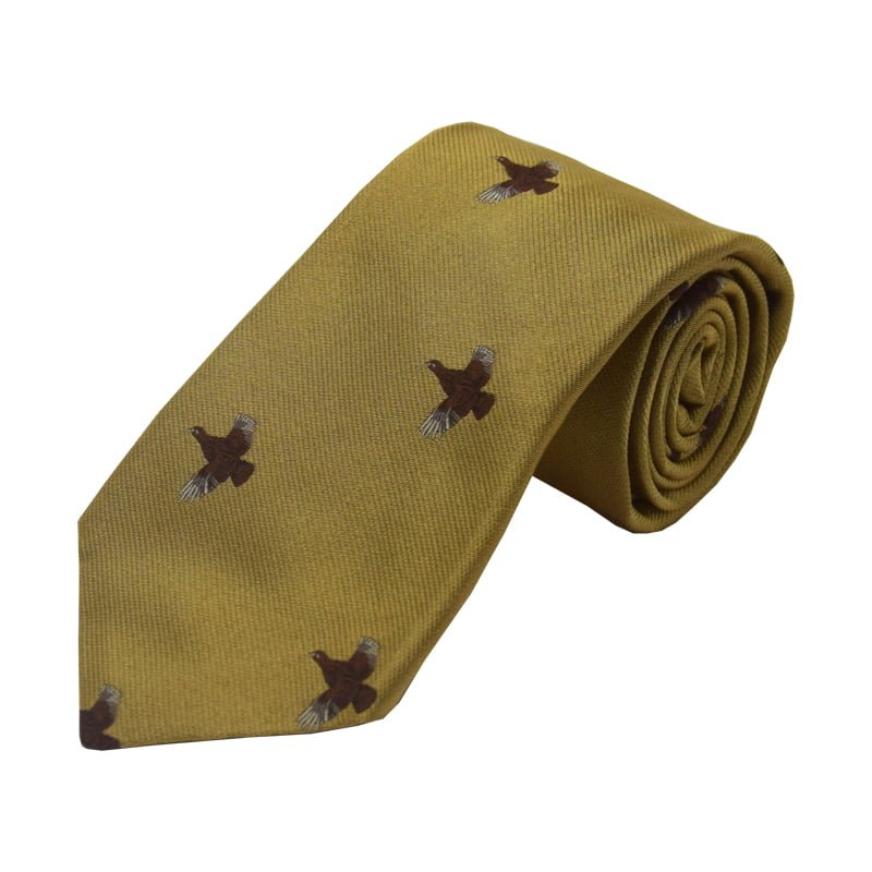 The Campbells of Beauly Full Flight Grouse Silk Tie is a gold, UK-made accessory featuring a charming repeating motif of brown grouse in flight.