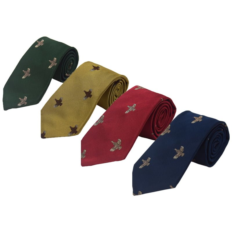 Four rolled Campbells of Beauly Full Flight Grouse Silk Ties in green, yellow, red, and blue, each handmade in the UK with a repeating embroidered countryside bird motif.