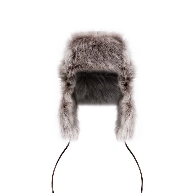 The Campbells of Beauly Toscana Sheepskin Trapper Hat is a fluffy gray ladies hat with ear flaps and long strings, shown on a white background.
