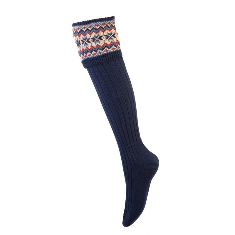 The Campbells of Beauly Merino Fairisle Shooting Socks in navy feature soft merino wool, a ribbed texture, and a colorful geometric patterned cuff in white, red, yellow, and blue.