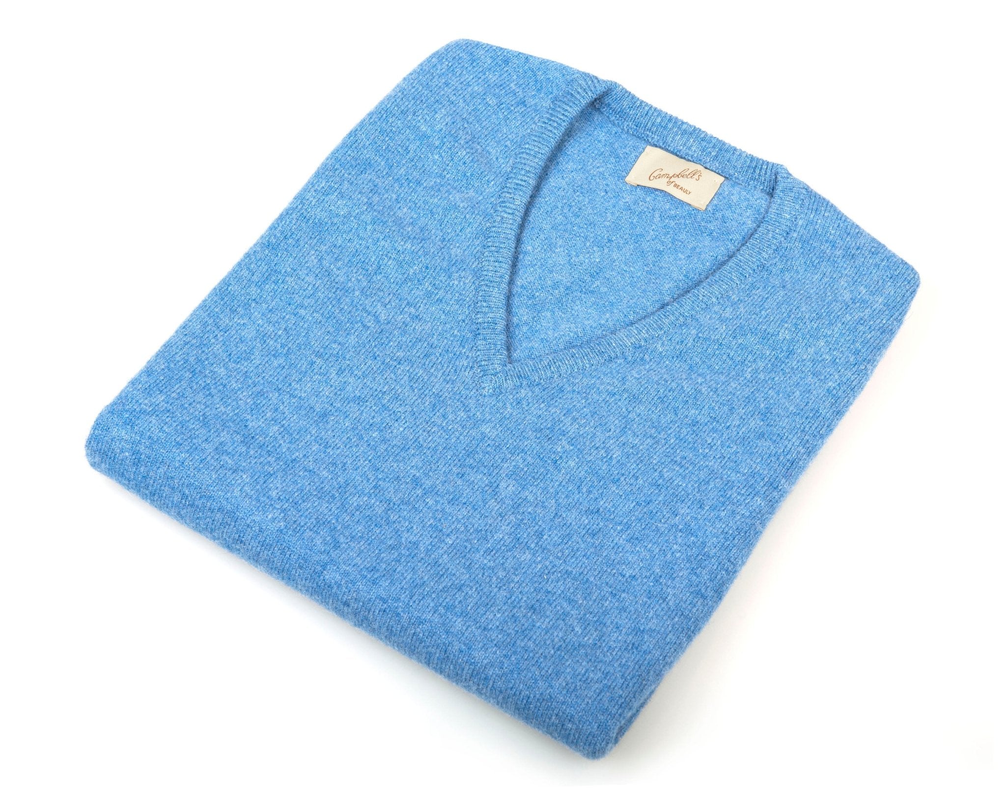 The Campbell's of Beauly Auld Stock Lambswool V-Neck Slipover in Lovat Blue, neatly folded with a visible beige label and made in Scotland, is displayed on a white background.
