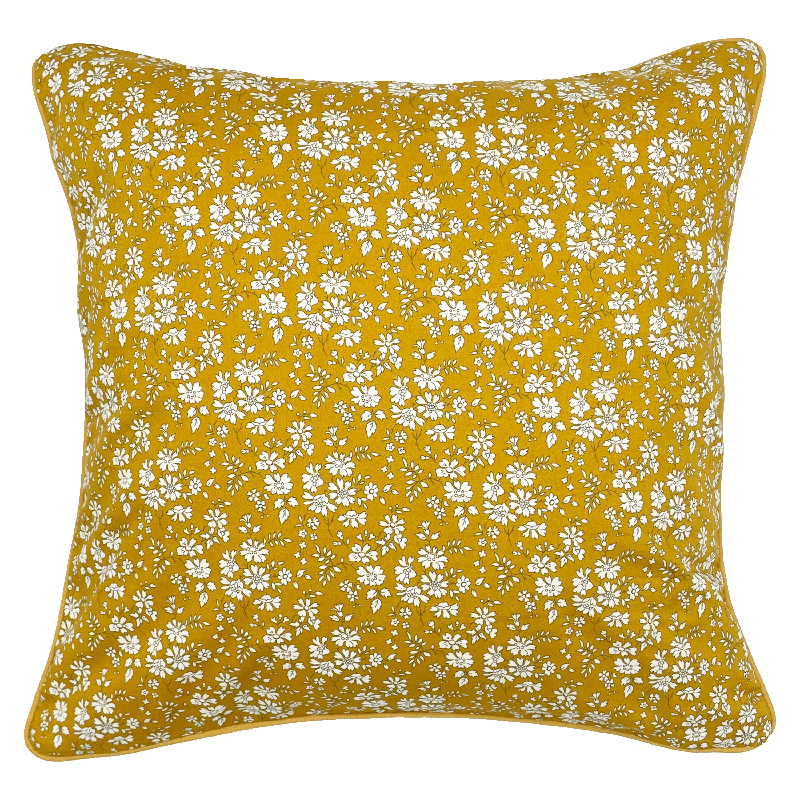 The Liberty Print Cushion Cover by Campbells of Beauly features a mustard yellow background with small white flowers, inspired by classic Liberty Tana Lawn designs—an elegant accent for any space.