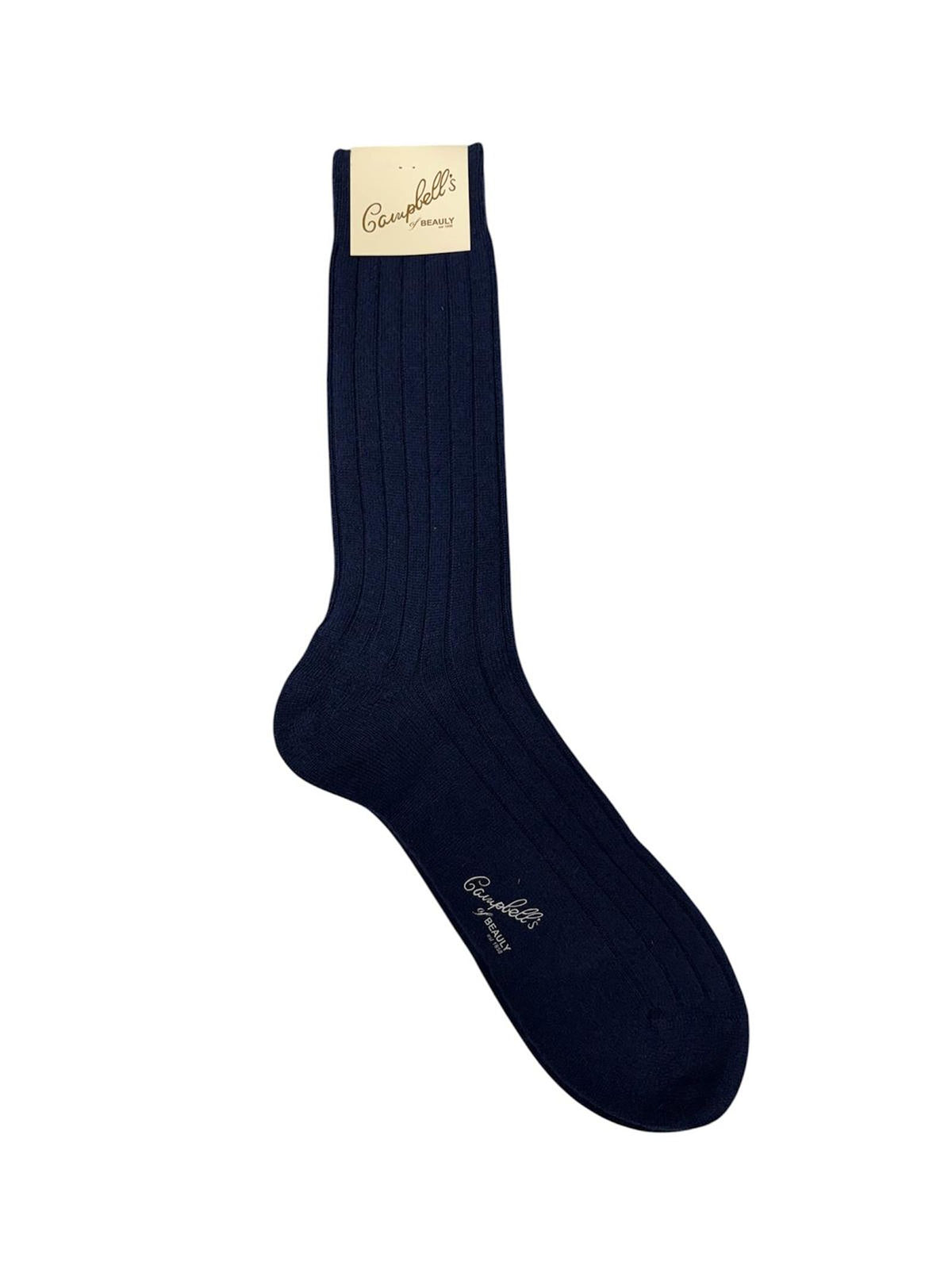 A single Rib Cashmere Sock from Campbell’s of Beauly in navy is displayed flat against a white background. The beige Campbell’s of Beauly label is attached at the top, drawing attention to the refined texture and luxurious quality of this elegant sock.