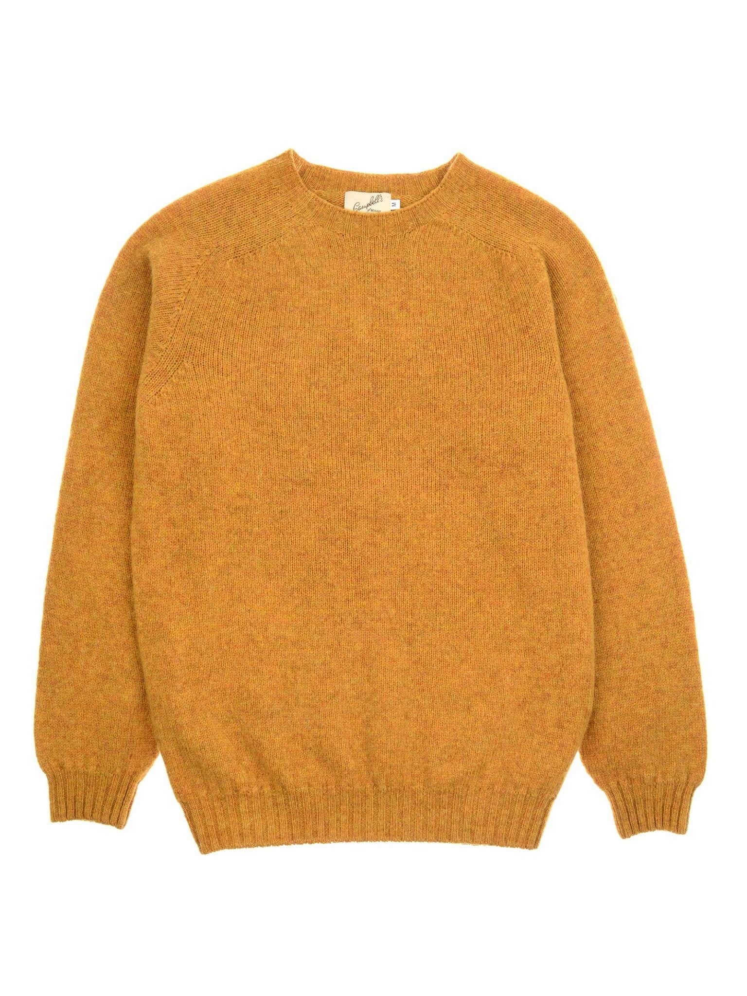 A mustard yellow long-sleeved Shetland Jumper by Campbell's of Beauly is laid flat on a white background. Crafted from soft lambswool, it features a crew neck with ribbed cuffs, waistband, and neckline.