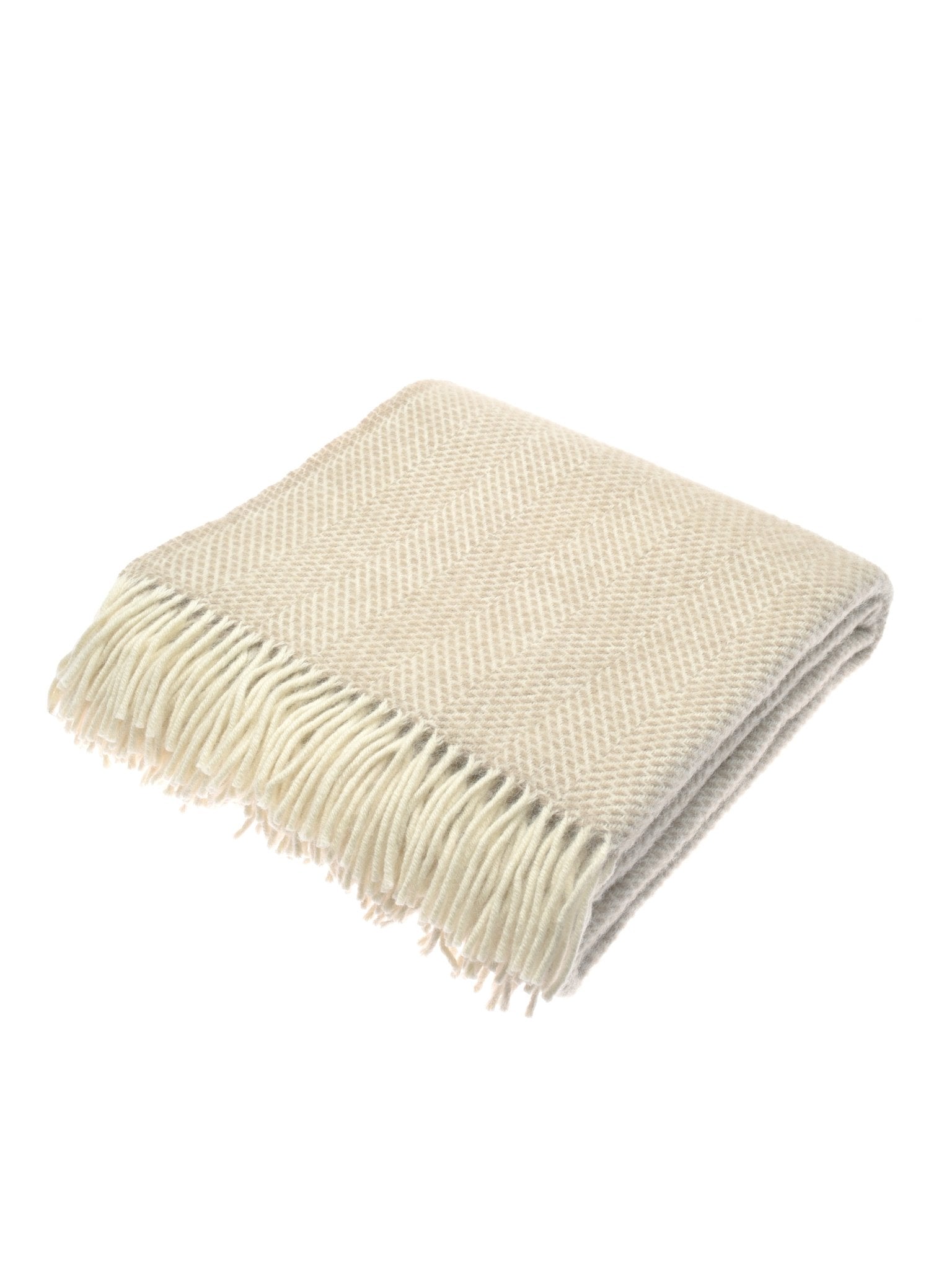 The Stipled Twill Blanket by Campbell's of Beauly is a folded, cream-colored UK woven blanket featuring a subtle chevron pattern and fringed edges, displayed on a white background.