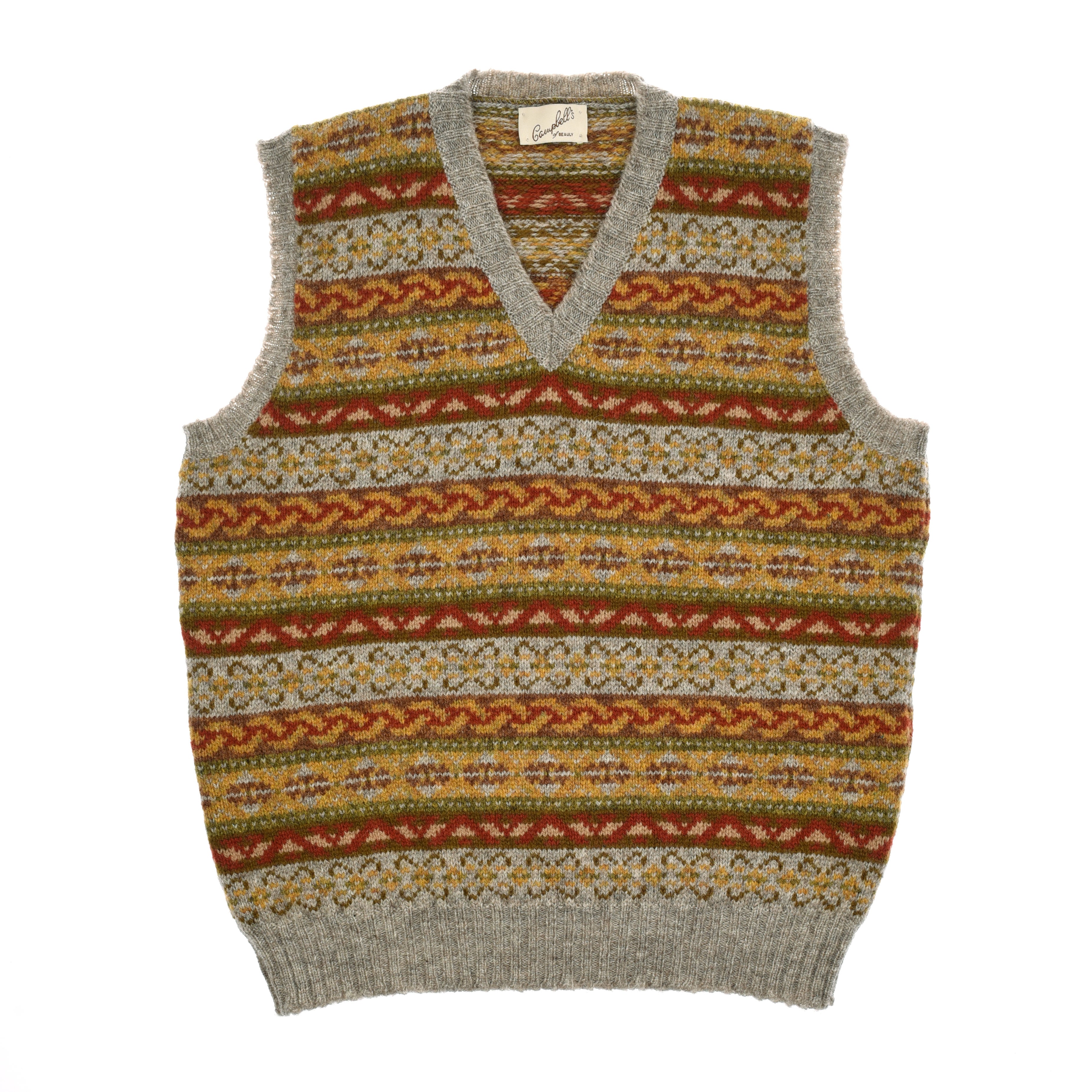 The Fairisle Slipover from Campbells of Beauly is a sleeveless V-neck vest in soft Shetland wool, featuring a grey base and colorful Fairisle pattern in red, mustard yellow, olive green, and white with ribbed edges.