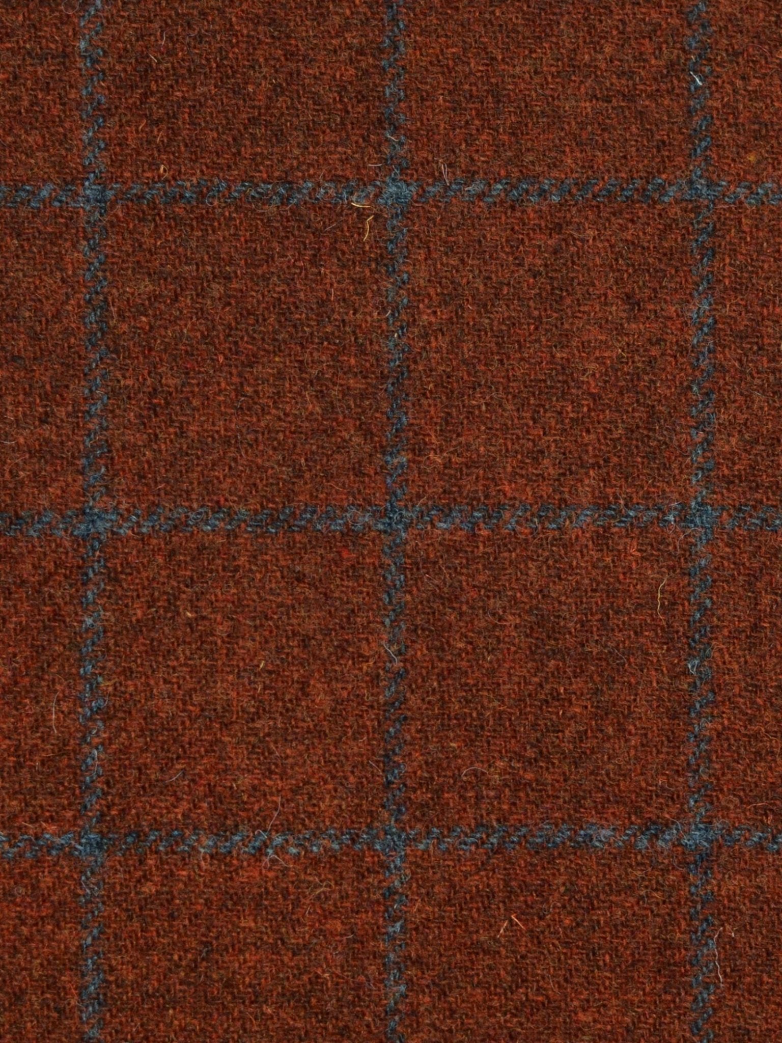 Close-up of Campbell's of Beauly House Tweed 93903, a featherweight tweed featuring a red-brown base and a blue grid of evenly spaced squares, showcasing classic Scottish tailoring style.
