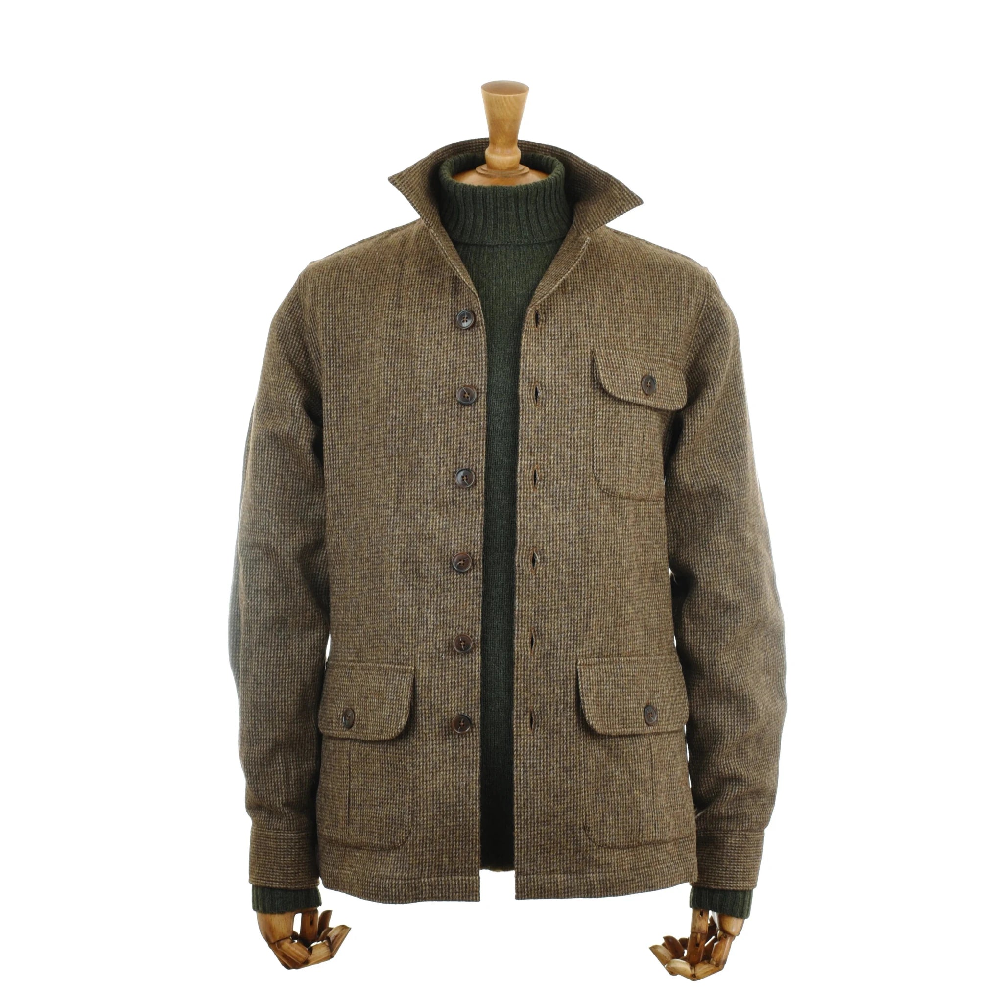 Campbell’s of Beauly Auld Stock Casual Shacket—a brown wool button-up jacket inspired by British tweed, featuring three front pockets and relaxed tailoring, is displayed on a mannequin with wooden hands and styled with a green turtleneck sweater underneath.
