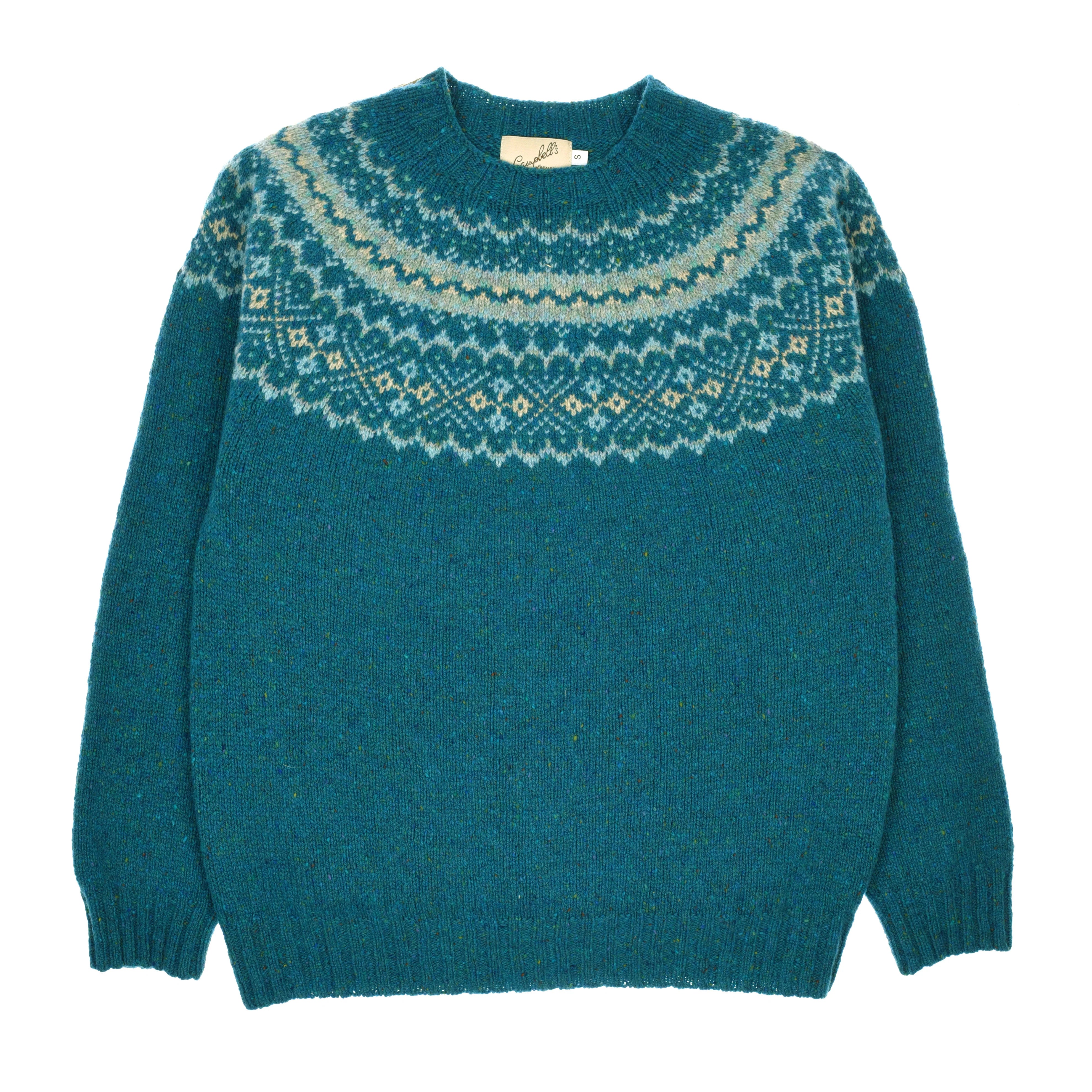 The Campbell's of Beauly Donegal Lambswool Fairisle Crew in Gigha features a round neckline and a Nordic-inspired geometric Fairisle pattern in white and light blue around the shoulders and chest.