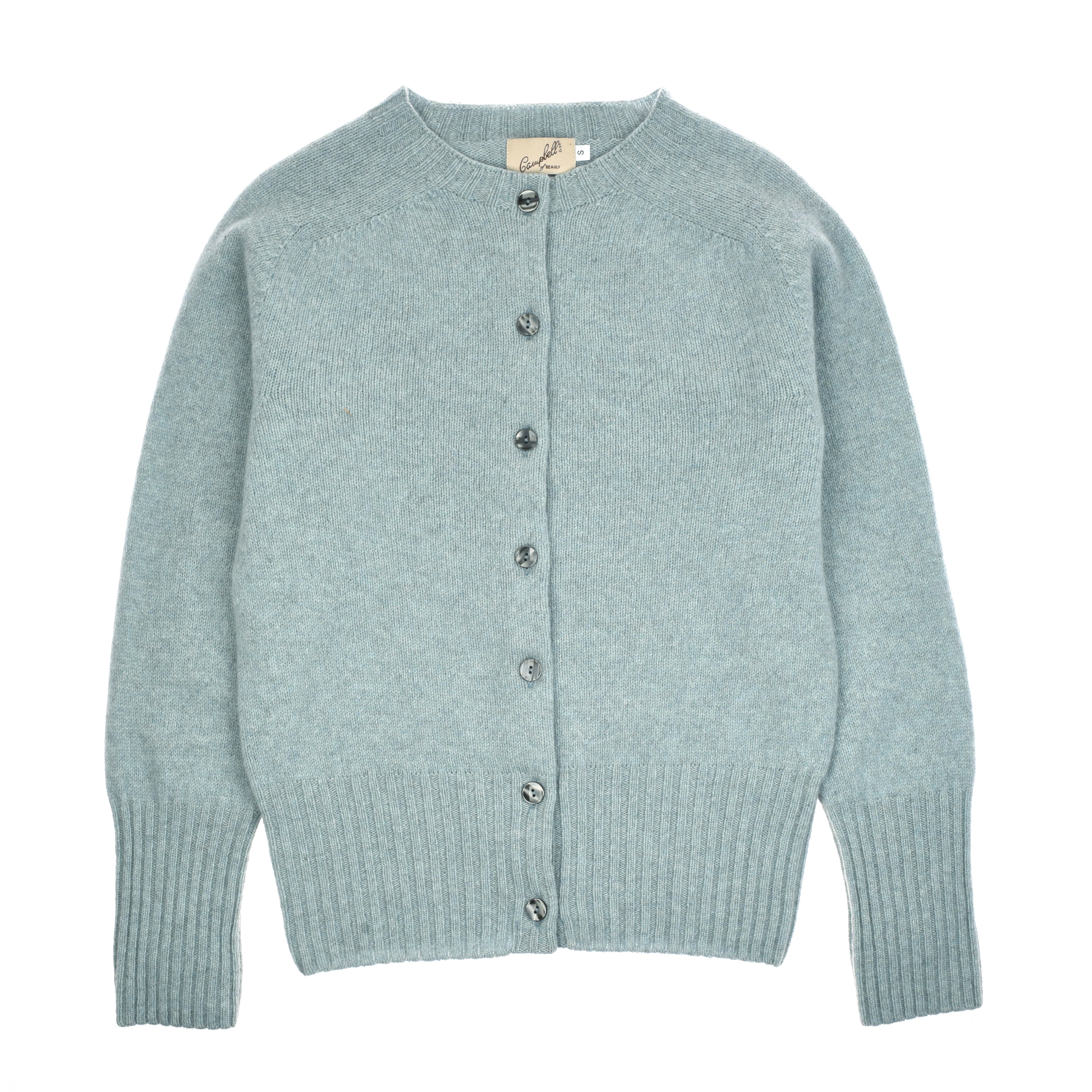 The Campbells of Beauly Crew Cardigan is a light blue, long-sleeved Geelong lambswool piece with ribbed cuffs and hem, seven marbled gray front buttons, a crew neck, slightly fuzzy texture, and visible neck label.