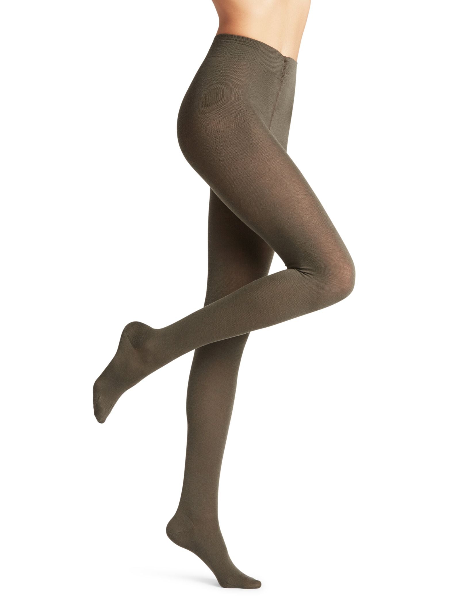 A model showcases FALKE Merino Tights in opaque olive green, posing against a plain white background with one leg bent and the other extended; only the tights are visible.