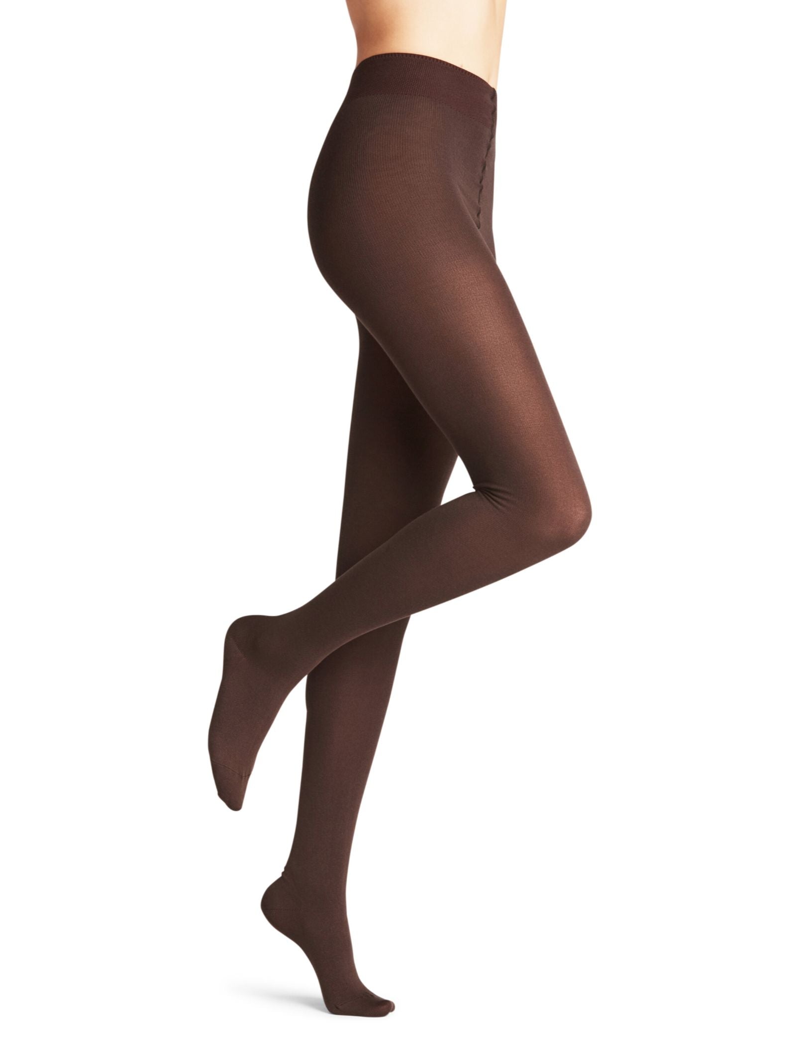 A person models opaque, footed brown FALKE Cotton Tights, standing on one leg with the other bent at the knee against a plain white background.