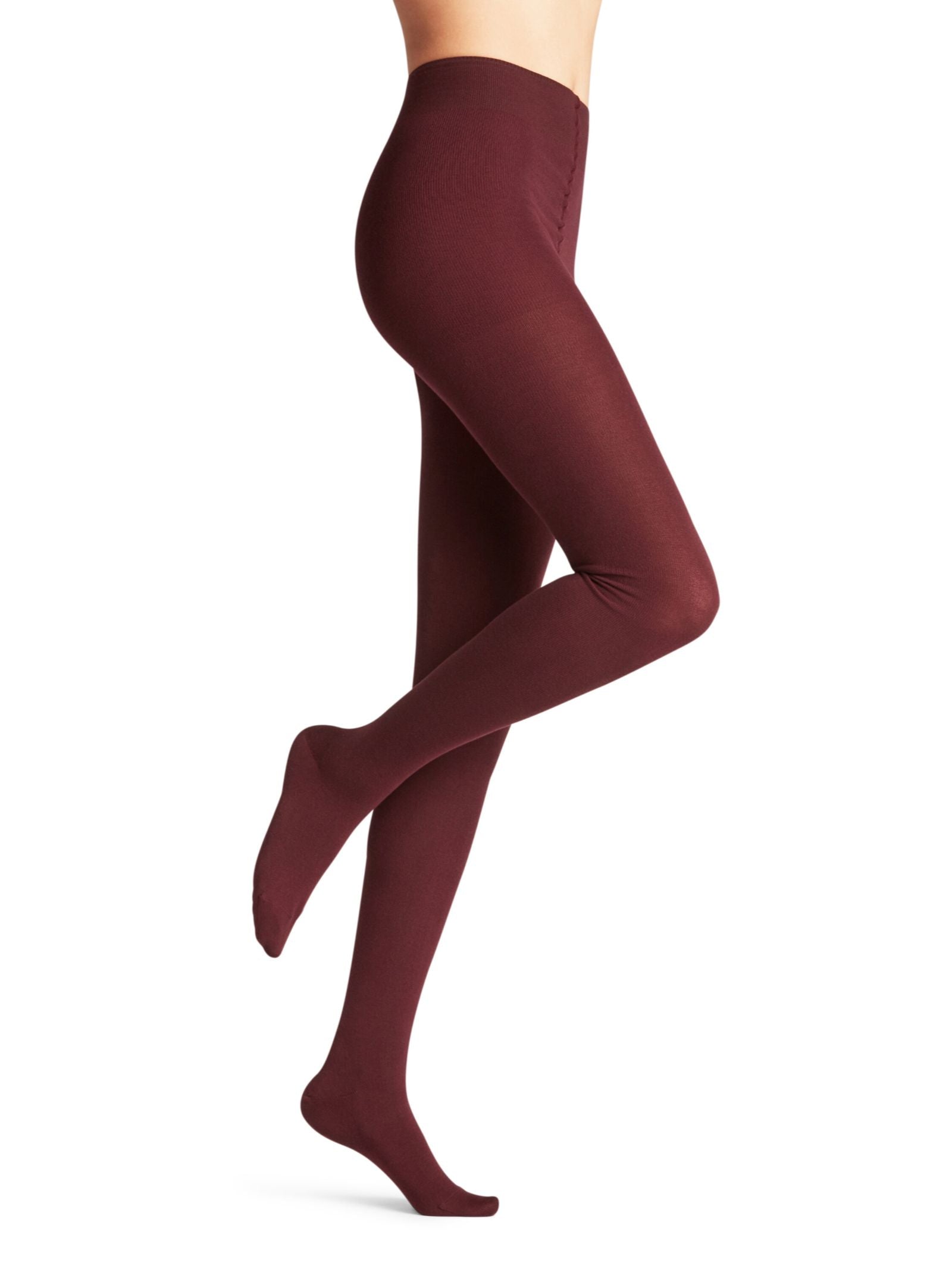 A person wearing high-waisted, opaque FALKE Cotton Tights in burgundy stands on tiptoe with one leg bent against a plain white background.