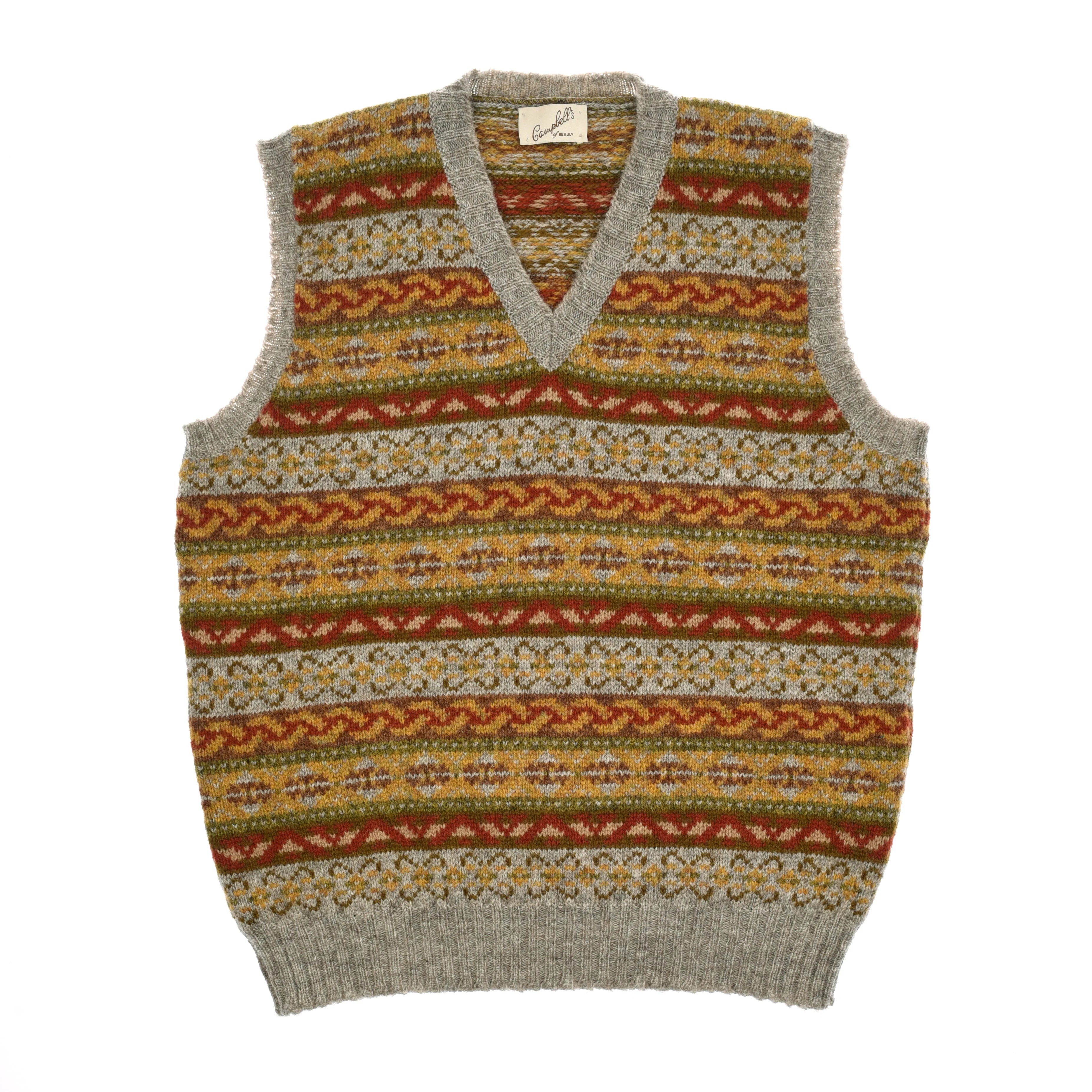 The Campbell’s of Beauly Fairisle Slipover is a classic wool vest crafted from Shetland wool, featuring a V-neck and traditional horizontal Fairisle patterns in yellow, orange, green, and gray. Designed as a sleeveless layer, it is finished with ribbed edges at the neck, armholes, and hem.
