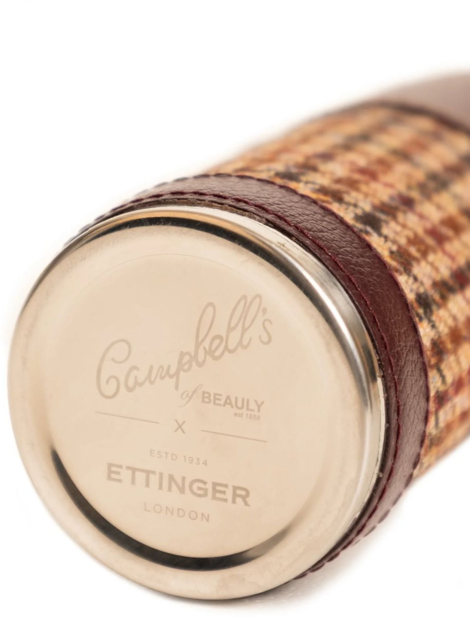 Close-up of the 8oz Bordeaux Hunter Flask by Campbell's of Beauly x Ettinger, featuring a metal cap, Capra goat leather wrap, and plaid fabric—a true showcase of fine British craftsmanship.