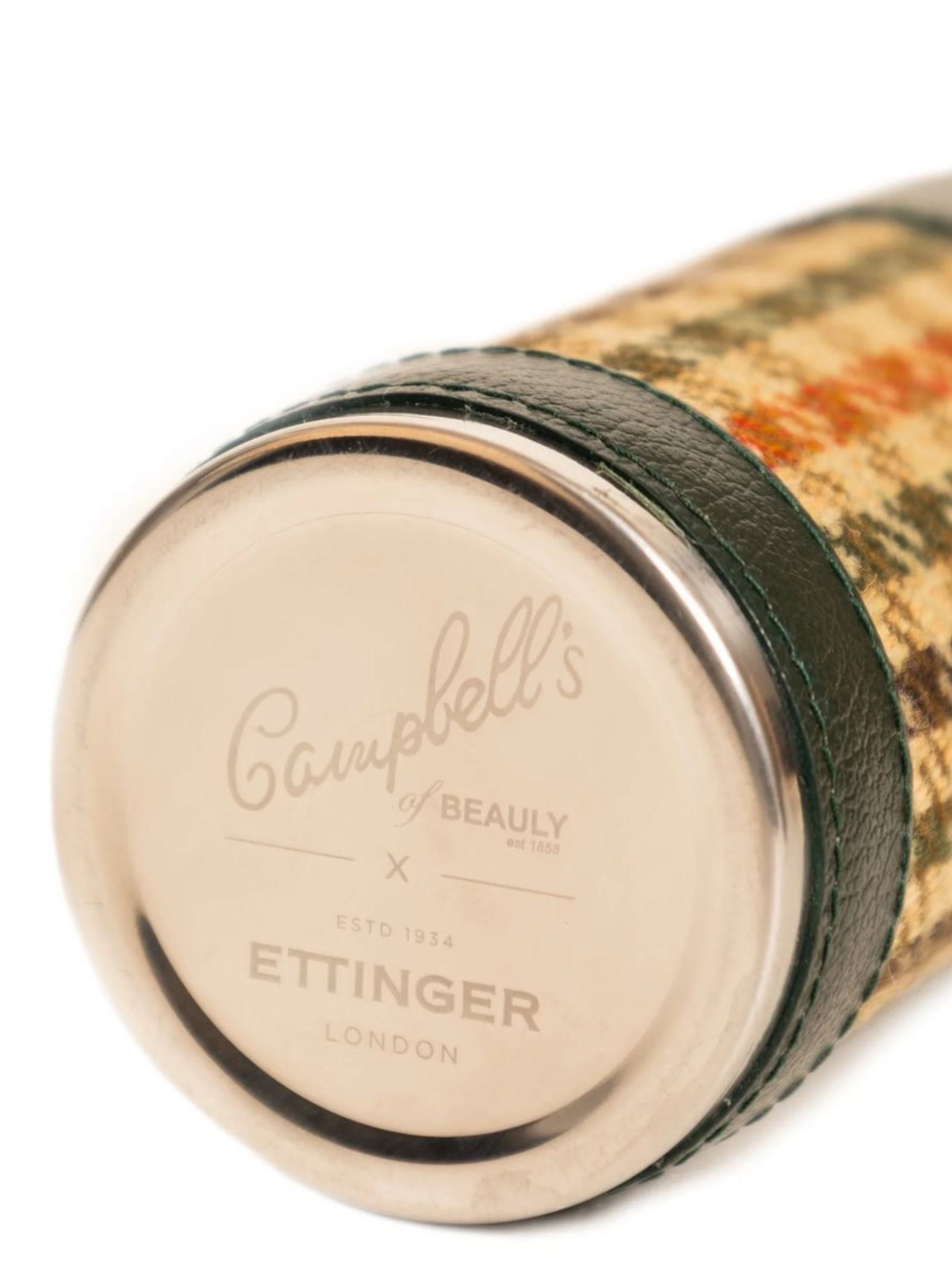 A close-up of the 8oz Forest Green Hunter Flask by Campbell's of Beauly x Ettinger, featuring patterned fabric, green Capra goat leather trim, and a metal end engraved with the brands—showcasing exquisite British craftsmanship.