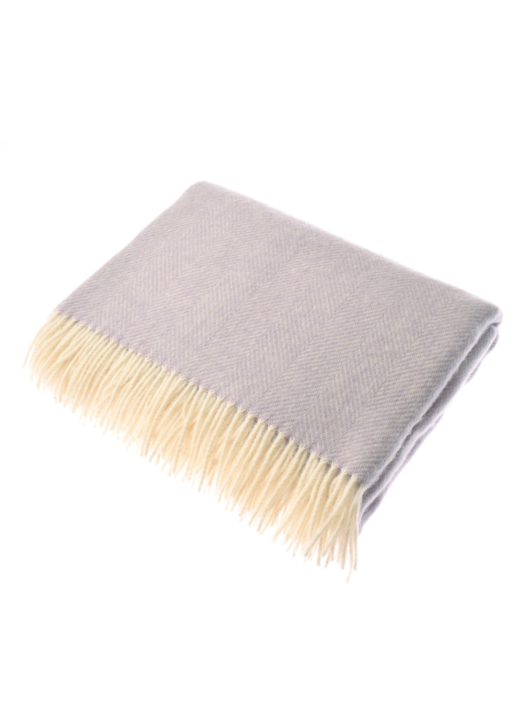 The Campbells of Beauly British Wool Throw, in light gray with a subtle herringbone pattern and cream fringe, woven in Scotland, is shown folded on a white background.