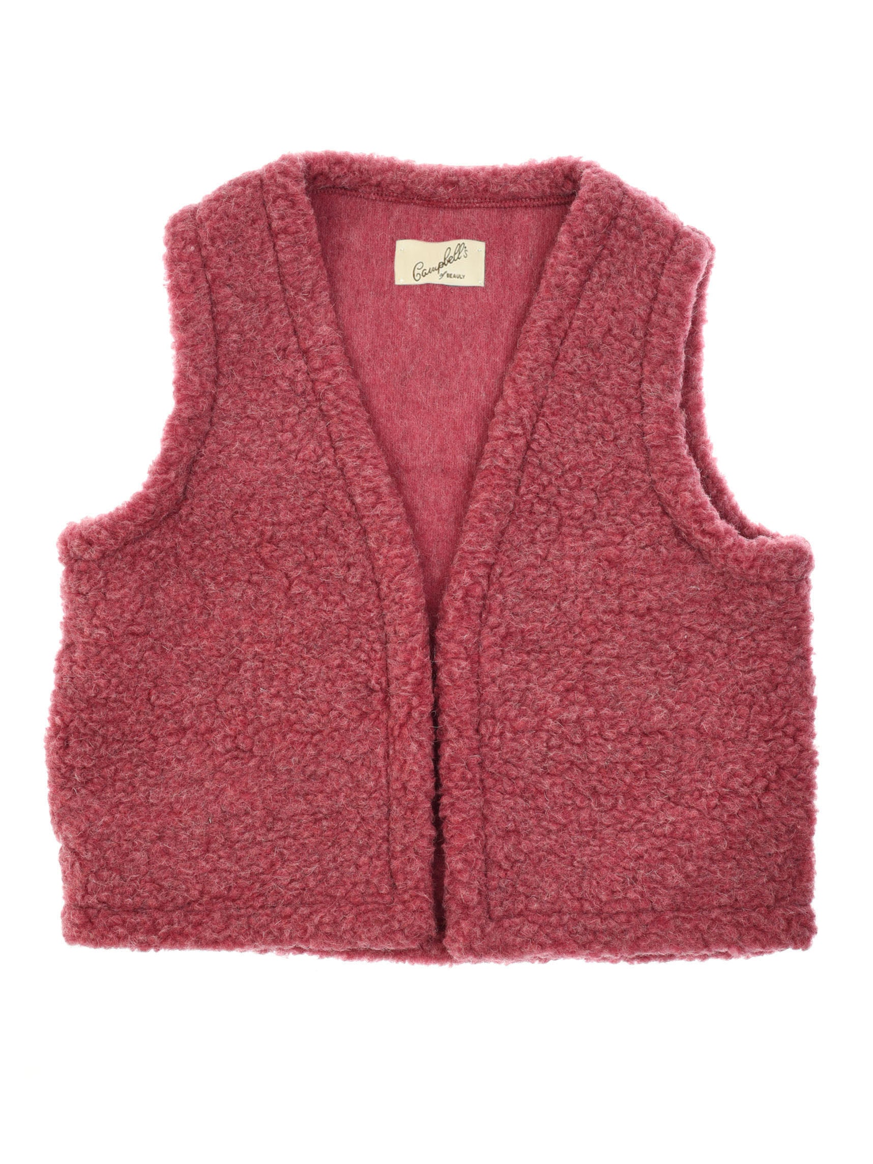 The Wool Shrug by Campbells of Beauly is a sleeveless, rose-pink sherpa fleece vest with a flat collar, wide armholes, open front, and an inner neck label—offering lightweight warmth and cozy style.