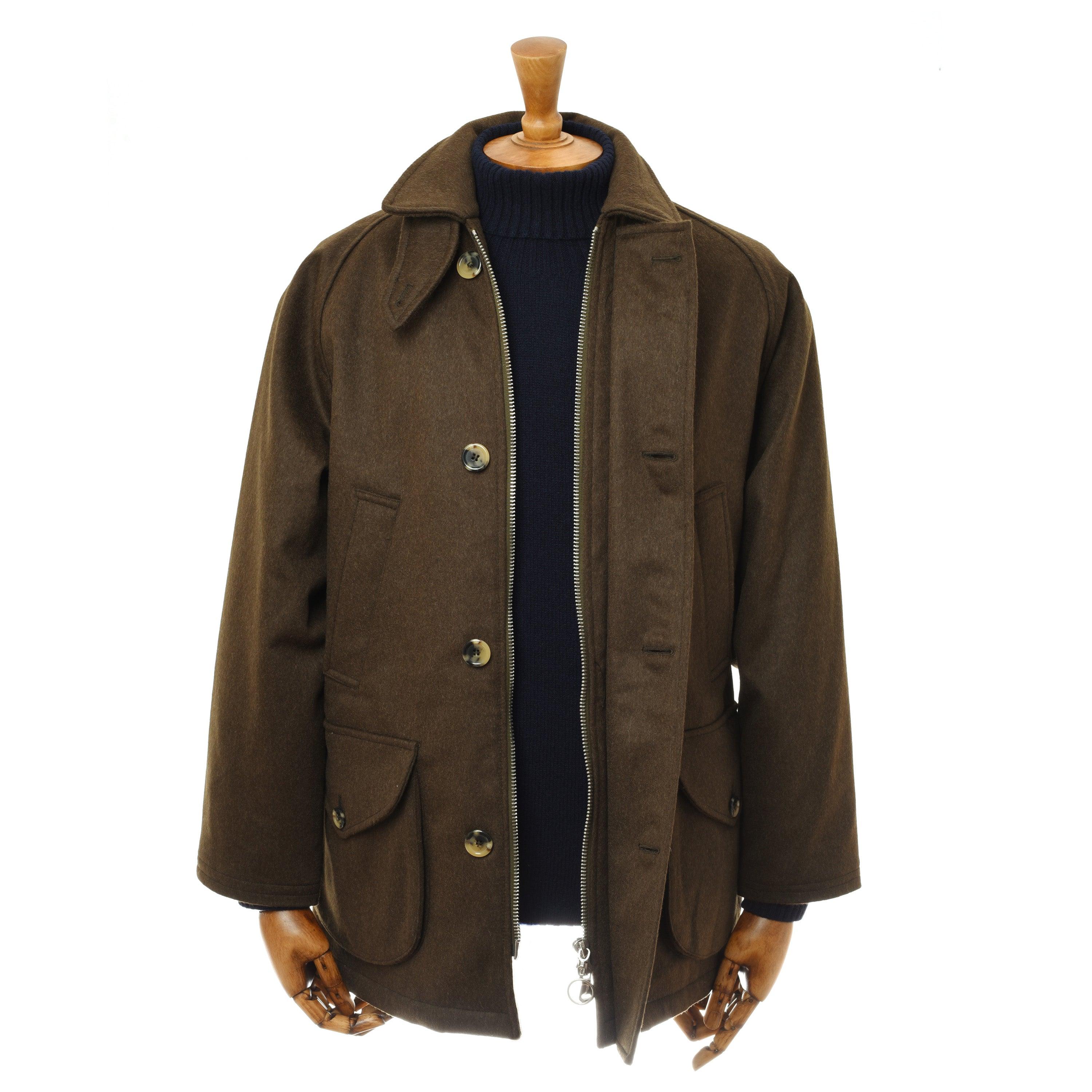 The Cannich Coat by Campbell’s of Beauly, a brown Austrian wool jacket with large buttons, collar, and flap pockets, is shown on a mannequin over a dark navy ribbed sweater against a plain white background. Both mannequin hands are visible.