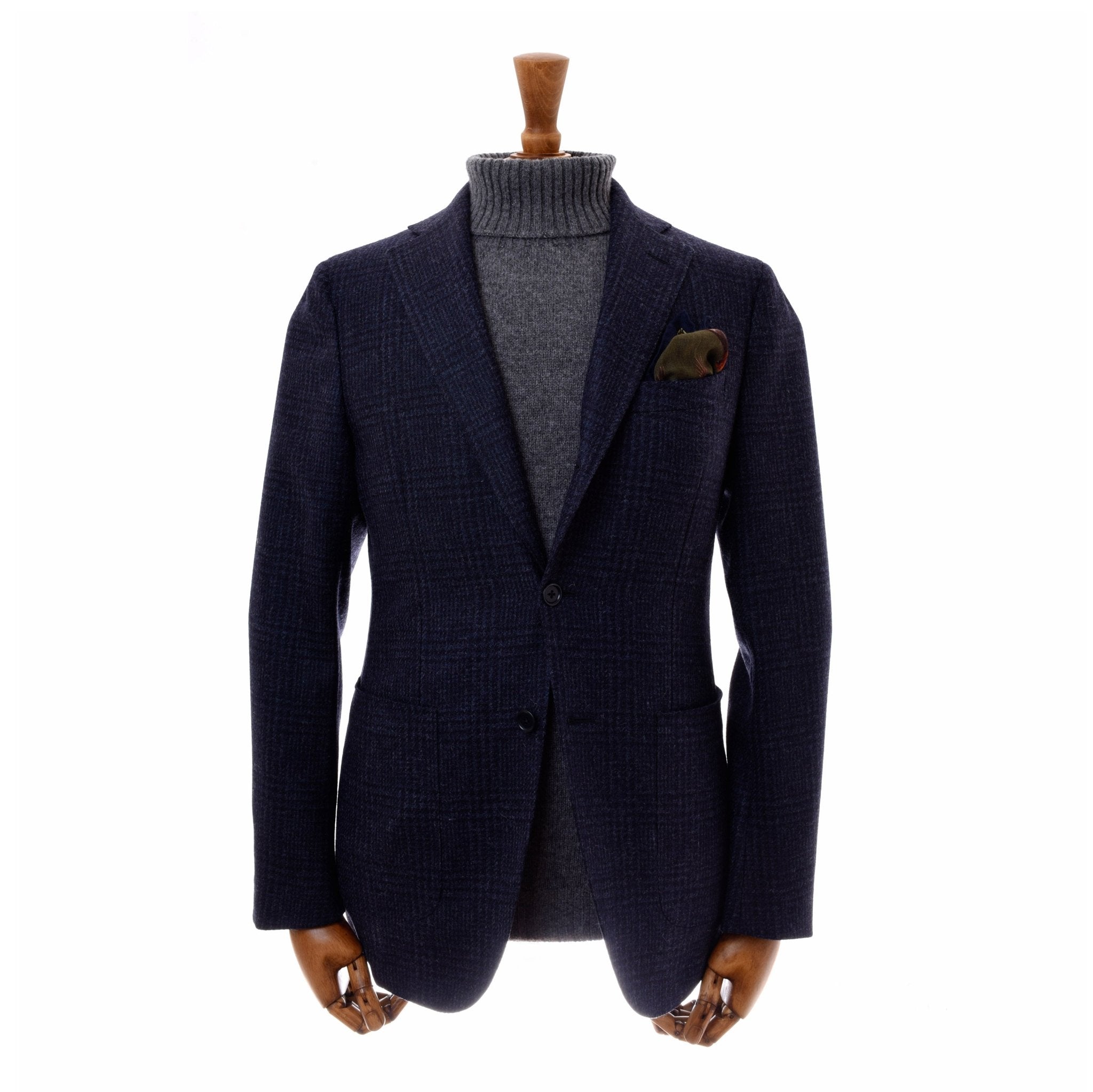 The Campbells of Beauly Glen Check Jacket in navy, styled with a pocket square over a gray turtleneck, is showcased on a wooden mannequin against a white background.