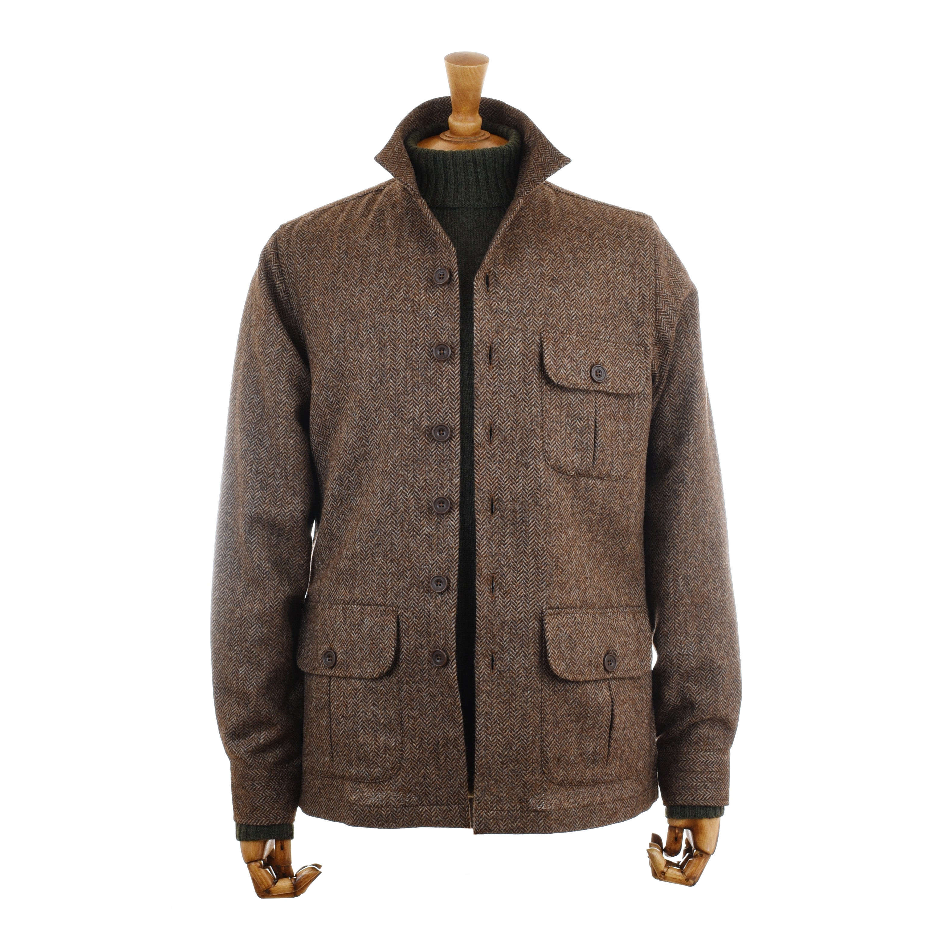A versatile staple, the Campbells of Beauly Casual Shacket in brown wool features four front flap pockets and brown buttons, styled over a green ribbed sweater on a mannequin with wooden hands against a plain white background.