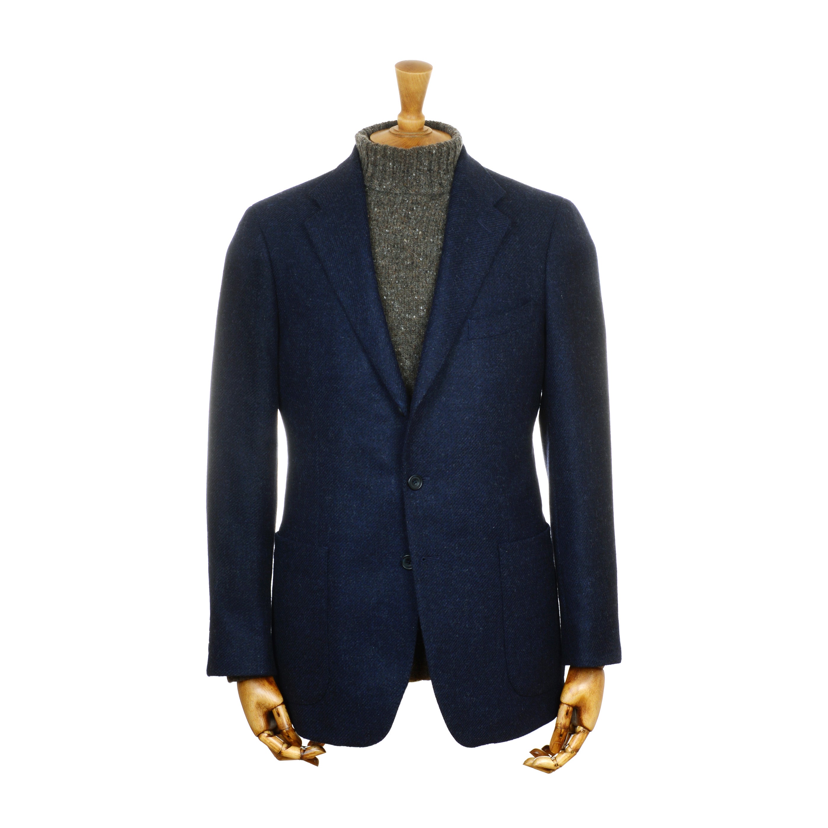 A Campbells of Beauly Navy Twill House Jacket with soft shoulders is shown on a mannequin dressed in a gray, high-neck knit sweater. The display features wooden hands and neck, set against a plain white background.