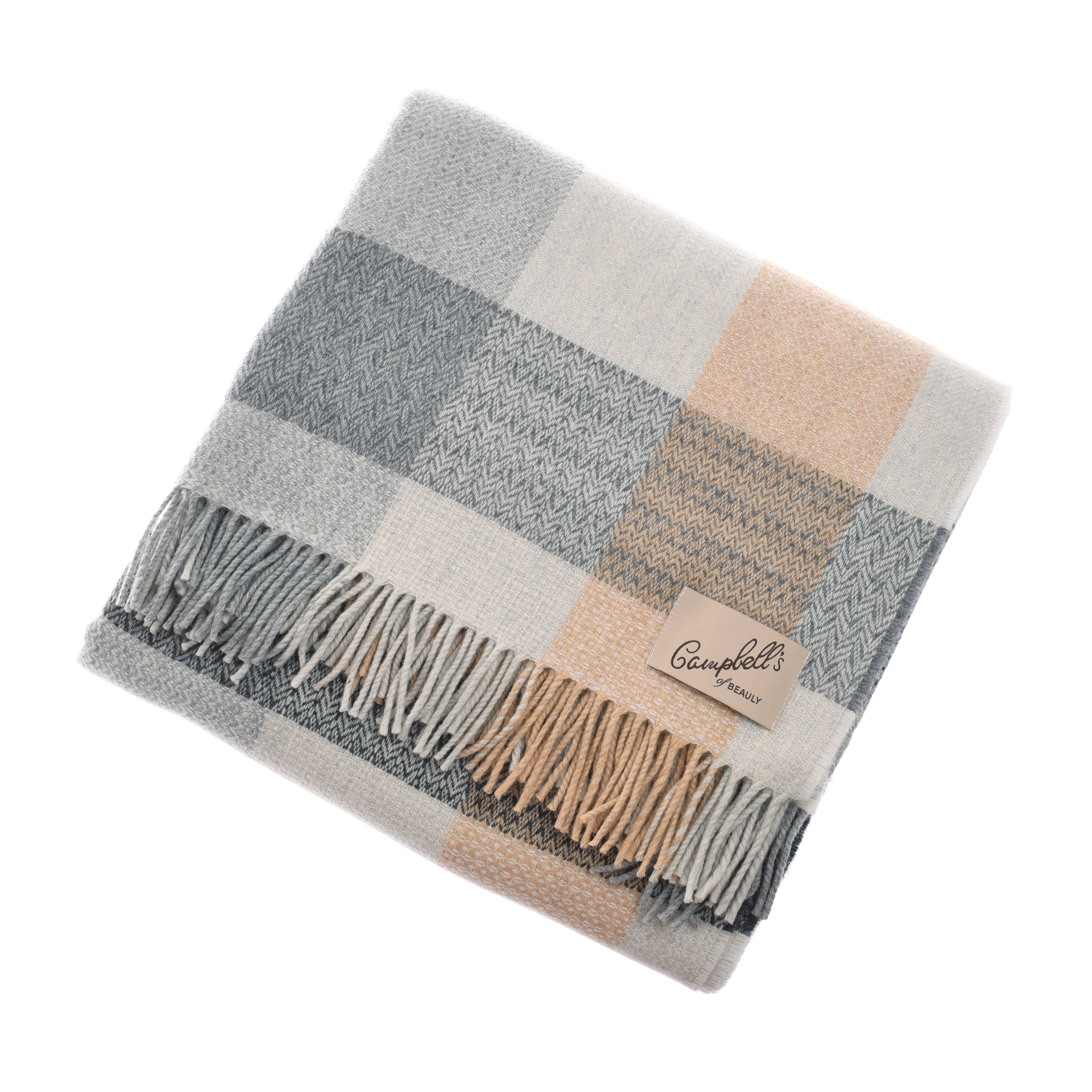 A folded Patchwork Throw by Campbells of Beauly featuring a plaid pattern in soft gray, cream, and beige tones. The blanket has fringed edges, a stitched beige label, and a cozy texture made with traditional weaving techniques.