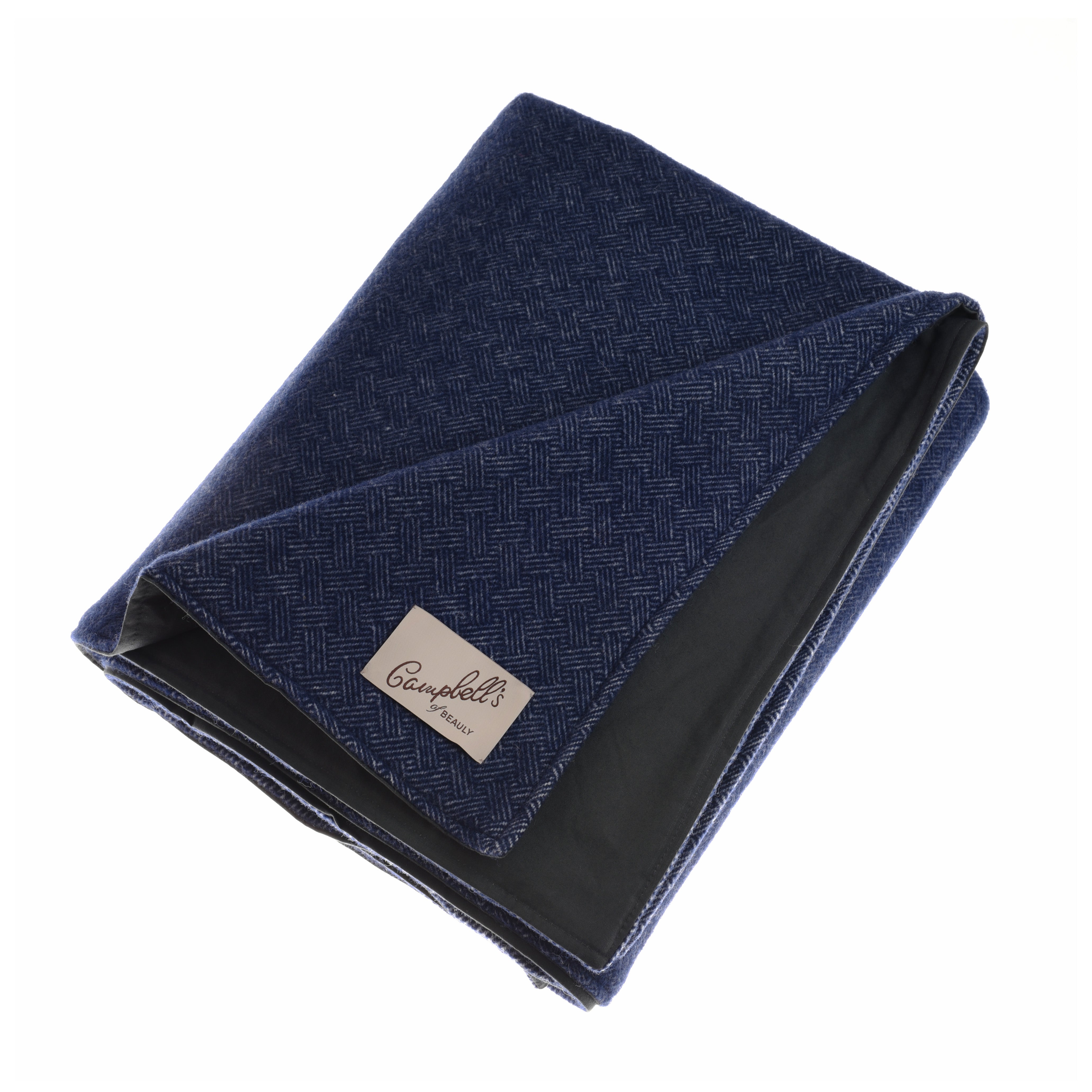 The Waterproof Picnic Blanket by Campbell’s of Beauly features a dark blue herringbone pattern, black lining, waterproof backing, and a beige “Campbell’s” label on the corner. It is neatly folded and shown against a plain white background.