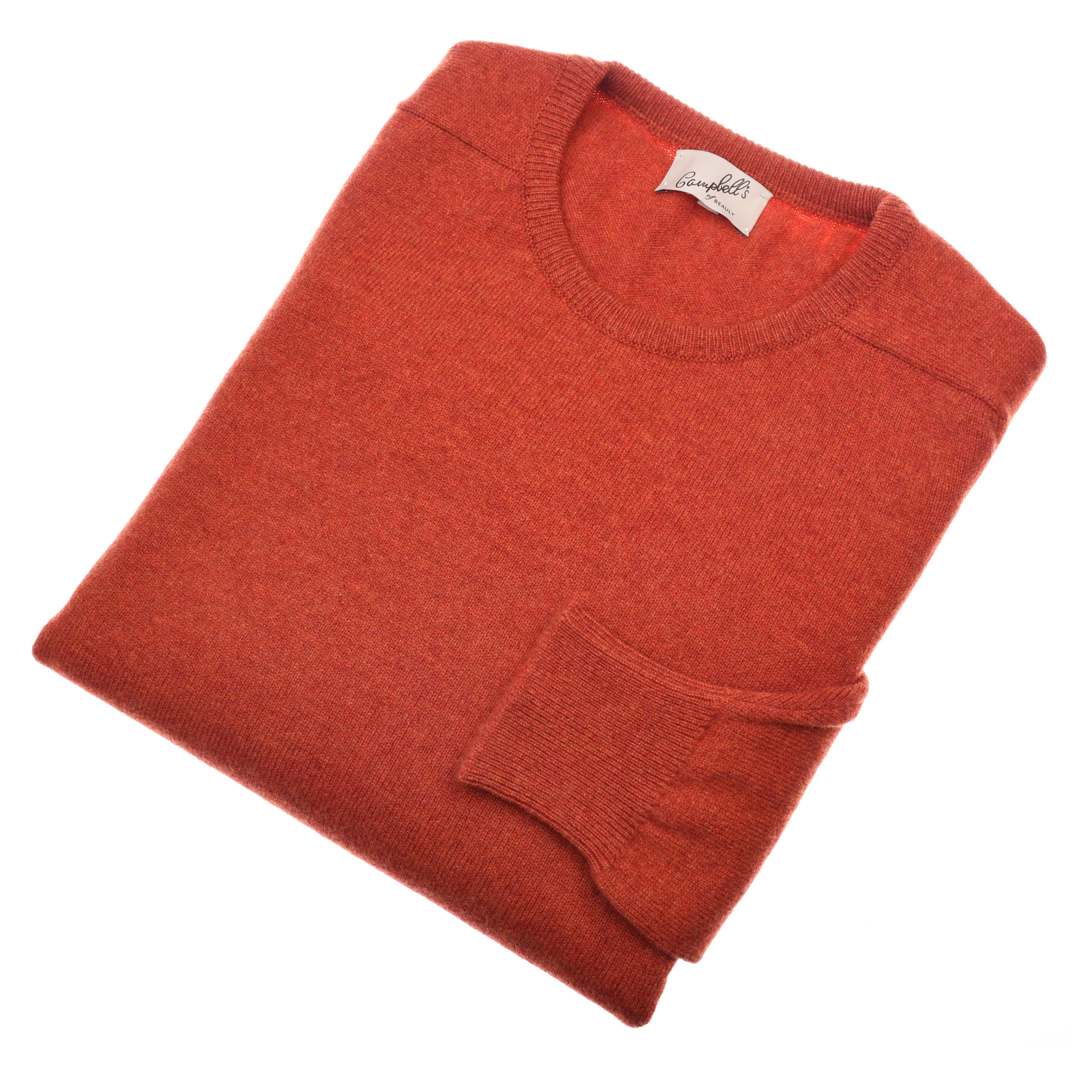 A folded, long-sleeved burnt orange Lambswool Crew Neck Jumper by Campbells of Beauly is displayed on a white background, with the left sleeve neatly over the front and a branded neck tag visible.