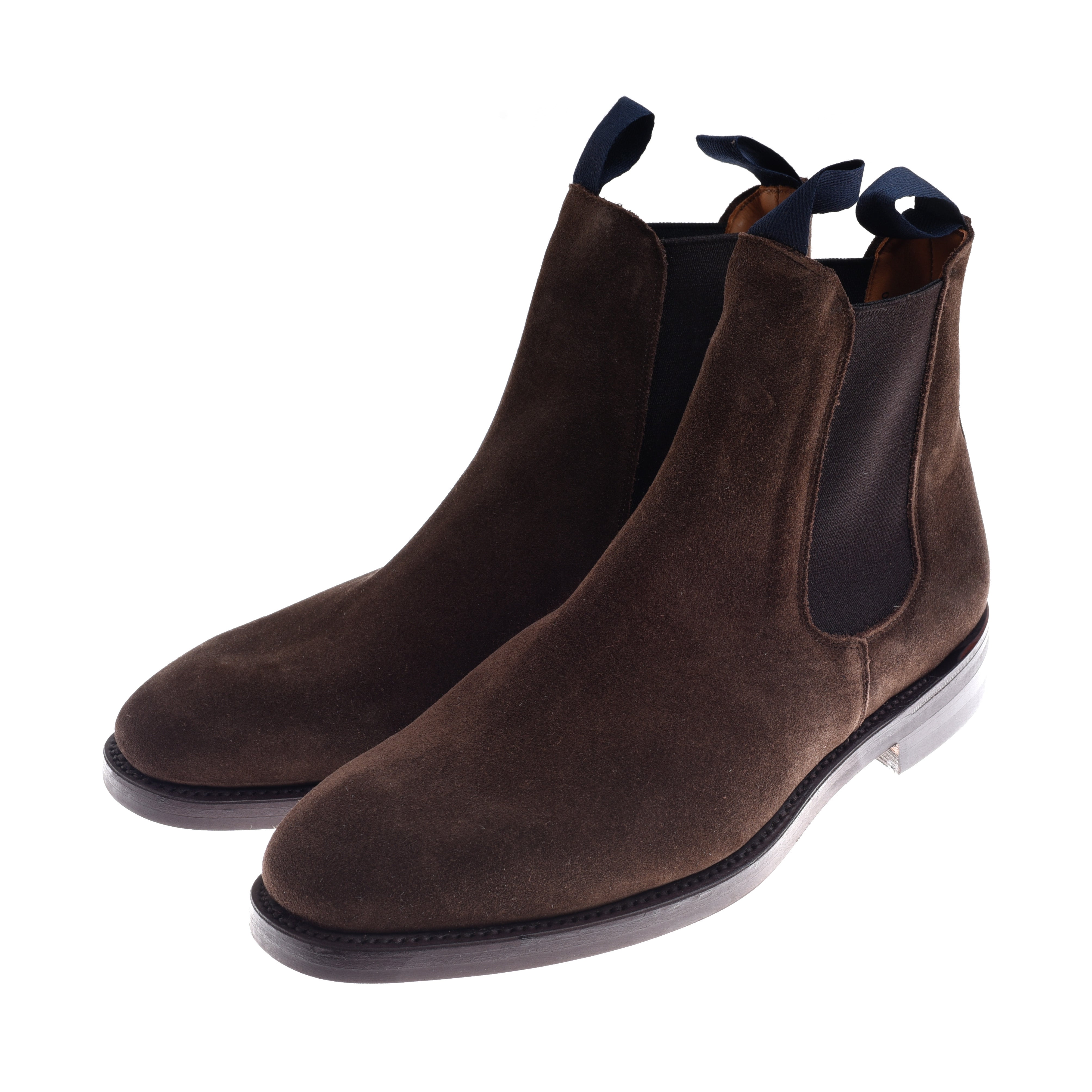 Campbells of Beauly Suede Chelsea Boots in dark brown feature black elastic side panels, navy pull tabs, a low heel, rounded toe, and a light-colored Commando sole with black trim. Displayed against a white background.
