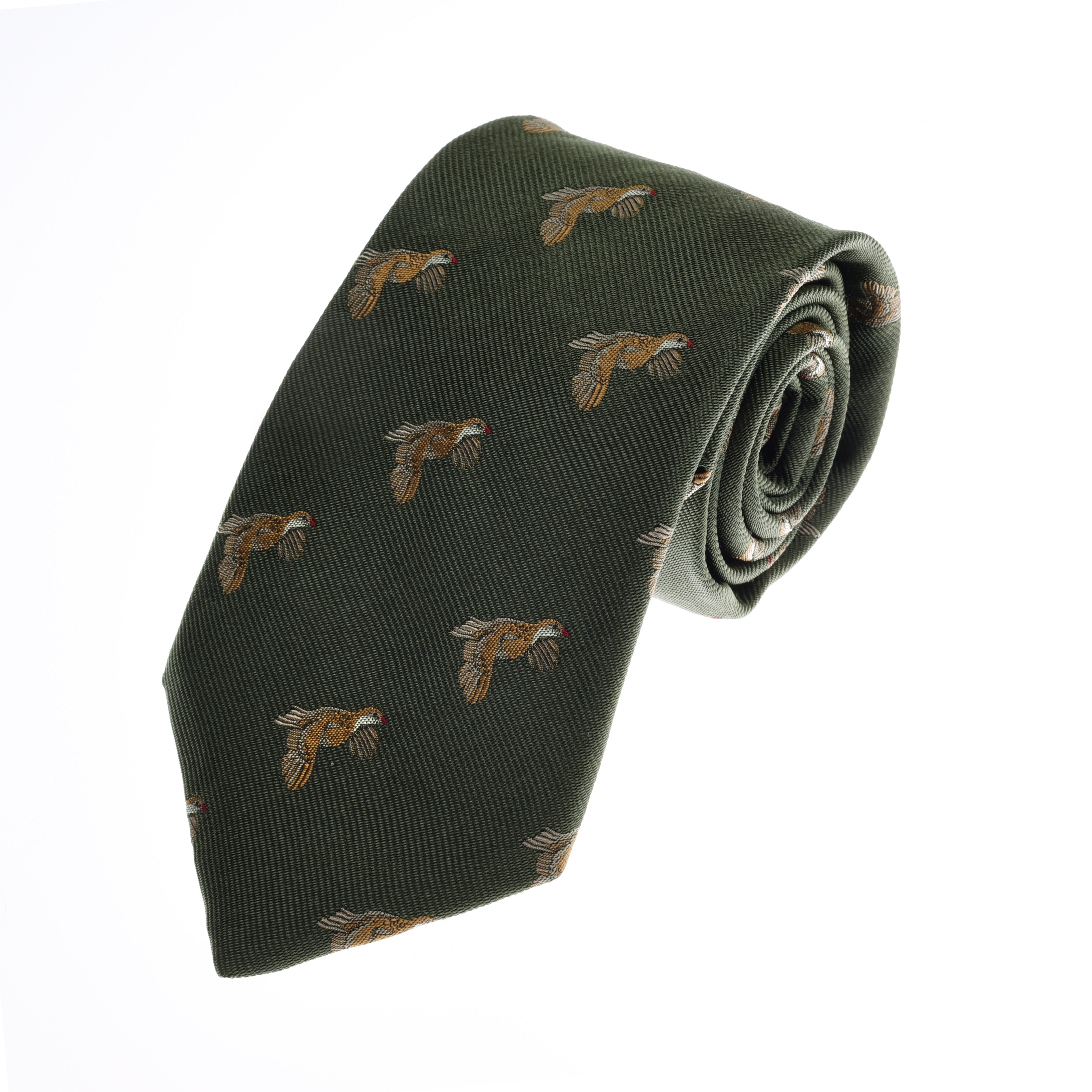 The Partridge Silk Tie by Campbells of Beauly is a dark green silk necktie featuring a repeating pattern of detailed partridges in brown, white, and red, shown rolled up against a plain white background.