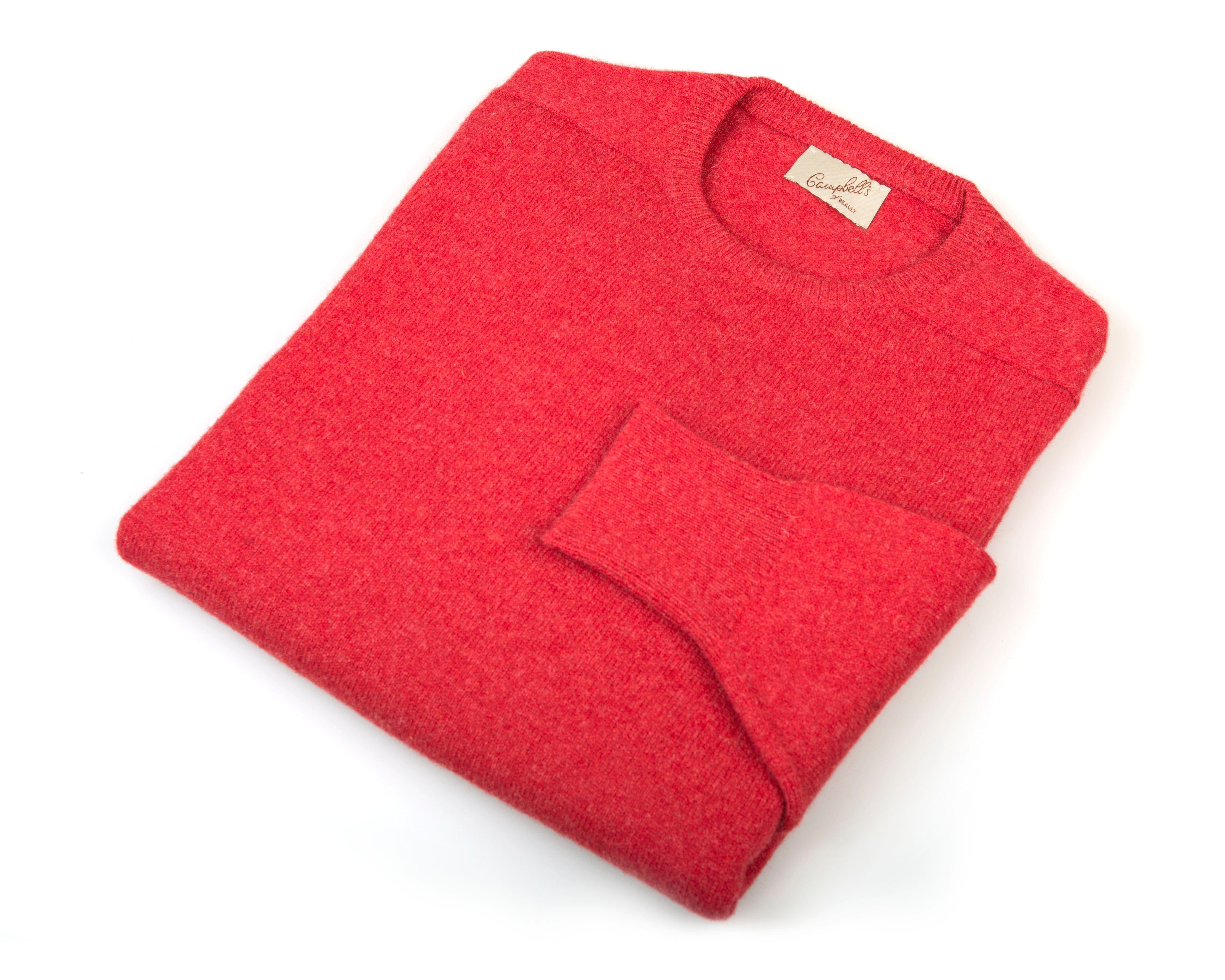 A bright red Lambswool Crew Neck Jumper by Campbells of Beauly, neatly folded on a white background with a visible collar label and one sleeve crossed in front, showcasing classic Scottish Borders style.