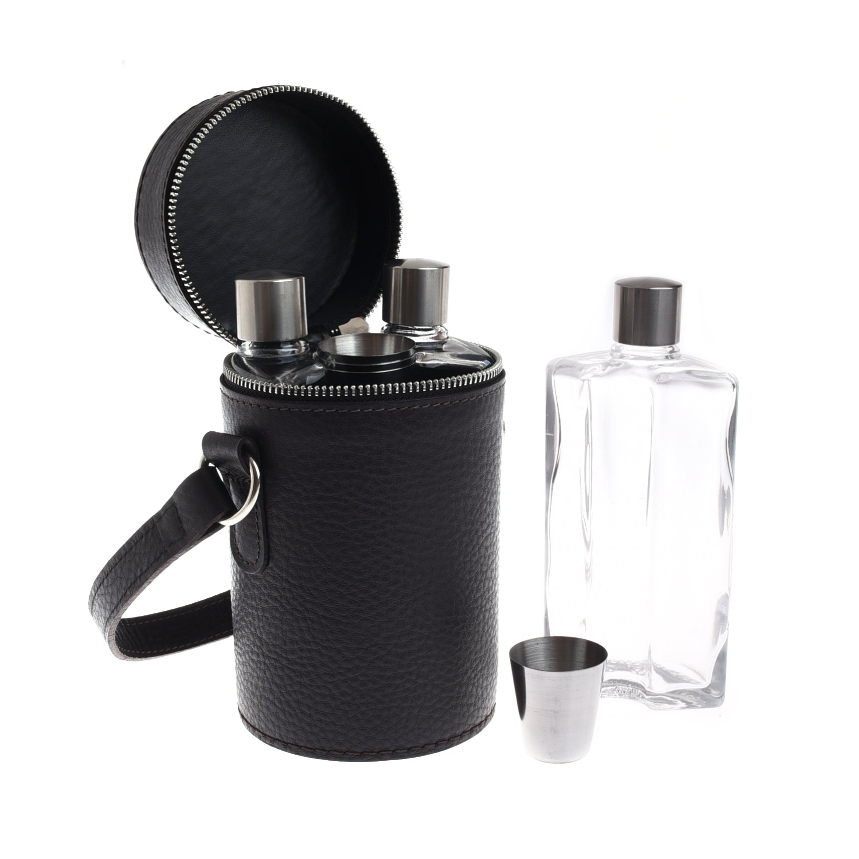 The Campbells of Beauly Triple Flask Set comes in a black leather zippered case with a handle and includes a metal shot glass. Next to it is a clear rectangular glass bottle with a silver cap, all arranged on a white background.