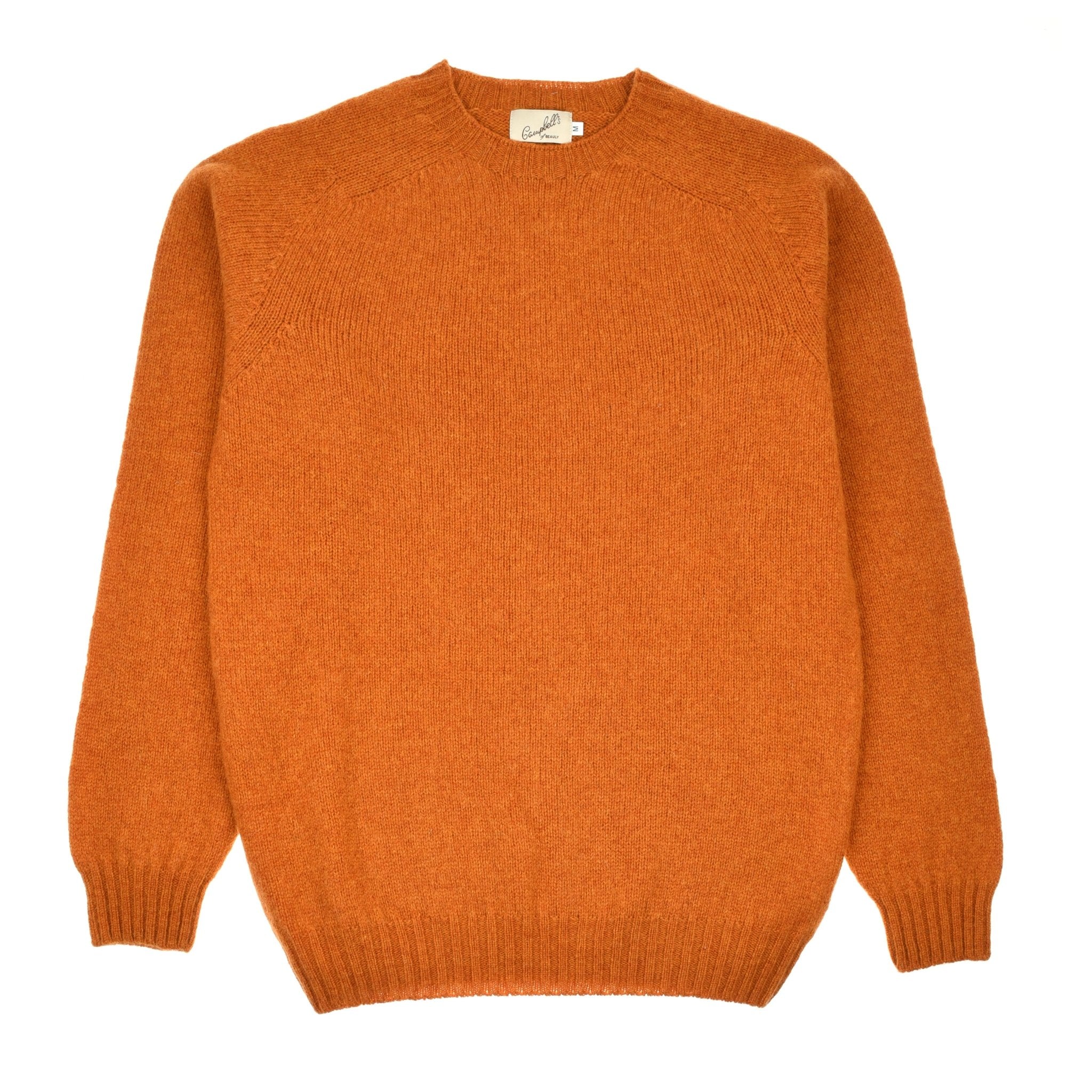 The Shetland Jumper by Campbells of Beauly in Autumn Leaf is a long-sleeve lambswool knit sweater with a crew neck, ribbed cuffs, and hem, shown laid flat on a white background.
