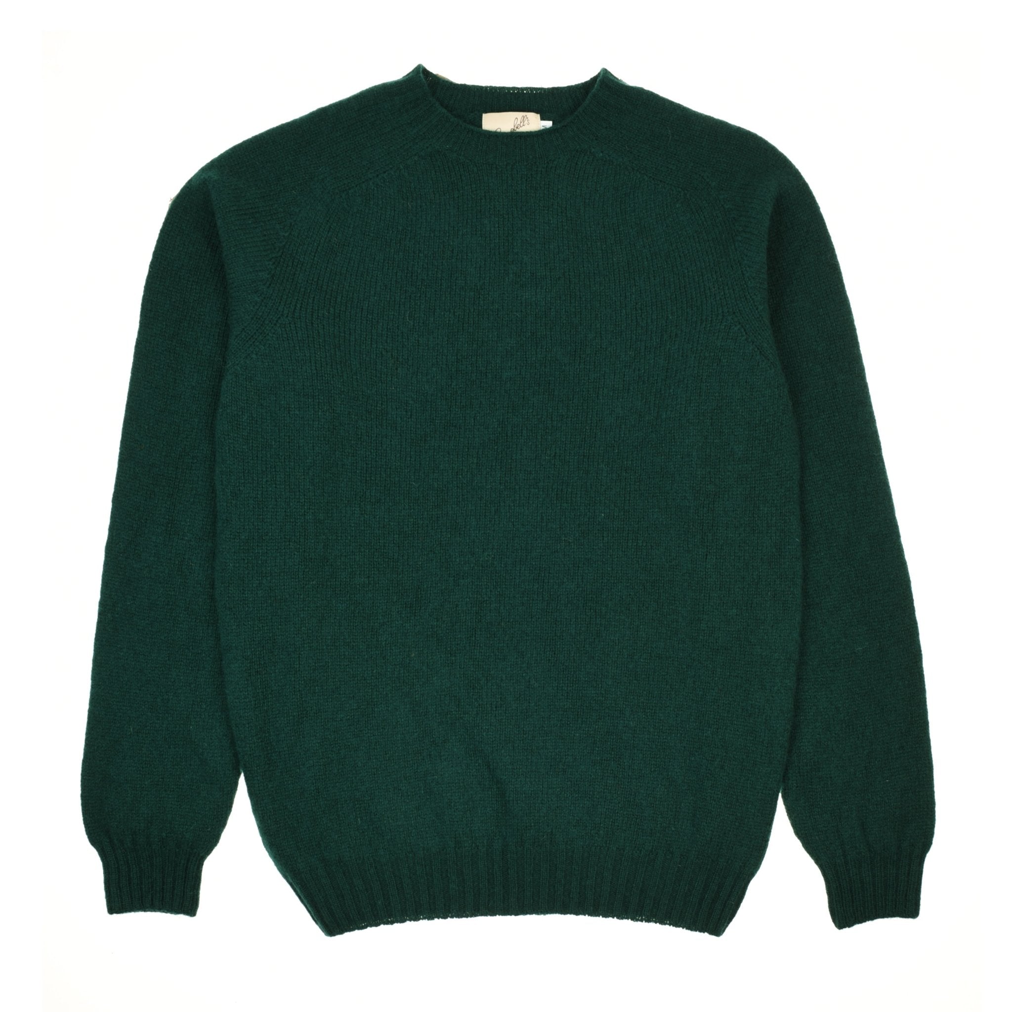 The Campbells of Beauly Shetland Jumper in Racing Green is crafted from soft lambswool yarn with long sleeves, a crew neckline, and ribbed cuffs and hem, shown laid flat on a white background.