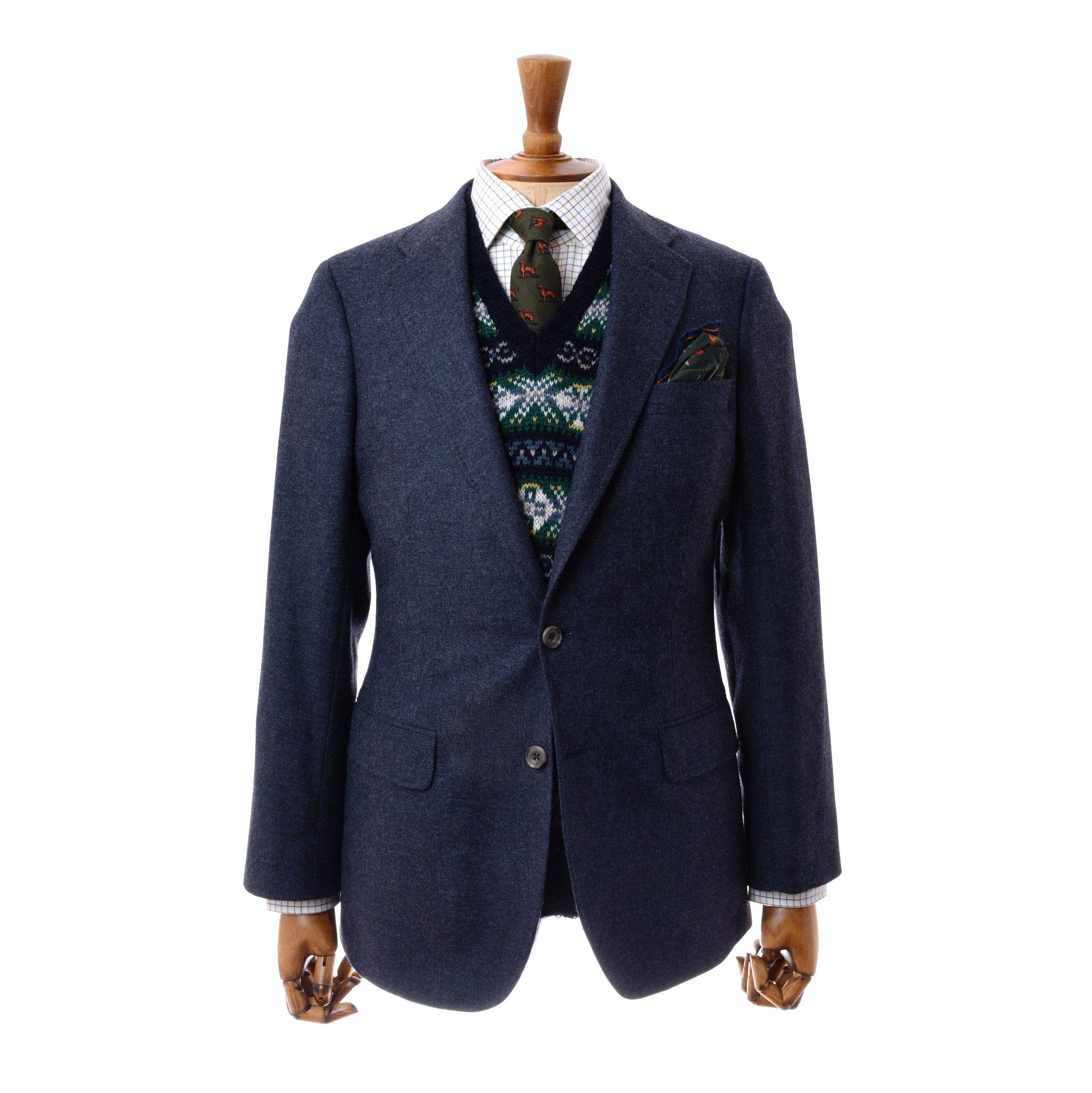 A wooden mannequin wears Campbells of Beauly Navy House Jacket in 100% wool over a patterned sweater vest, white checked shirt, green patterned tie, with a matching pocket square in the blazer’s breast pocket against a plain white background.