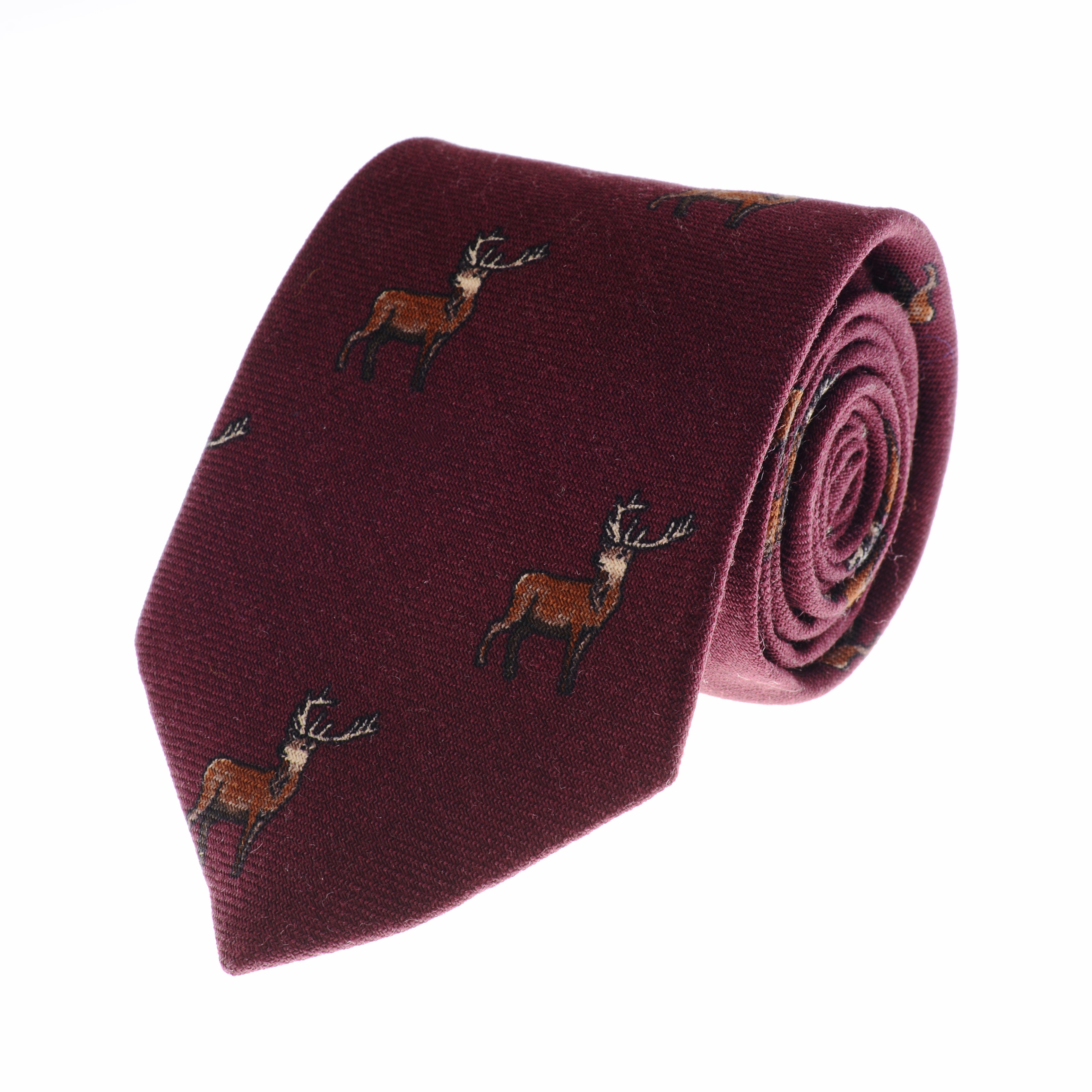 The Campbells of Beauly Stag Silk Tie features a burgundy background with small brown embroidered stags. Handmade from premium silk, its neatly rolled to highlight its countryside charm against a plain white background.