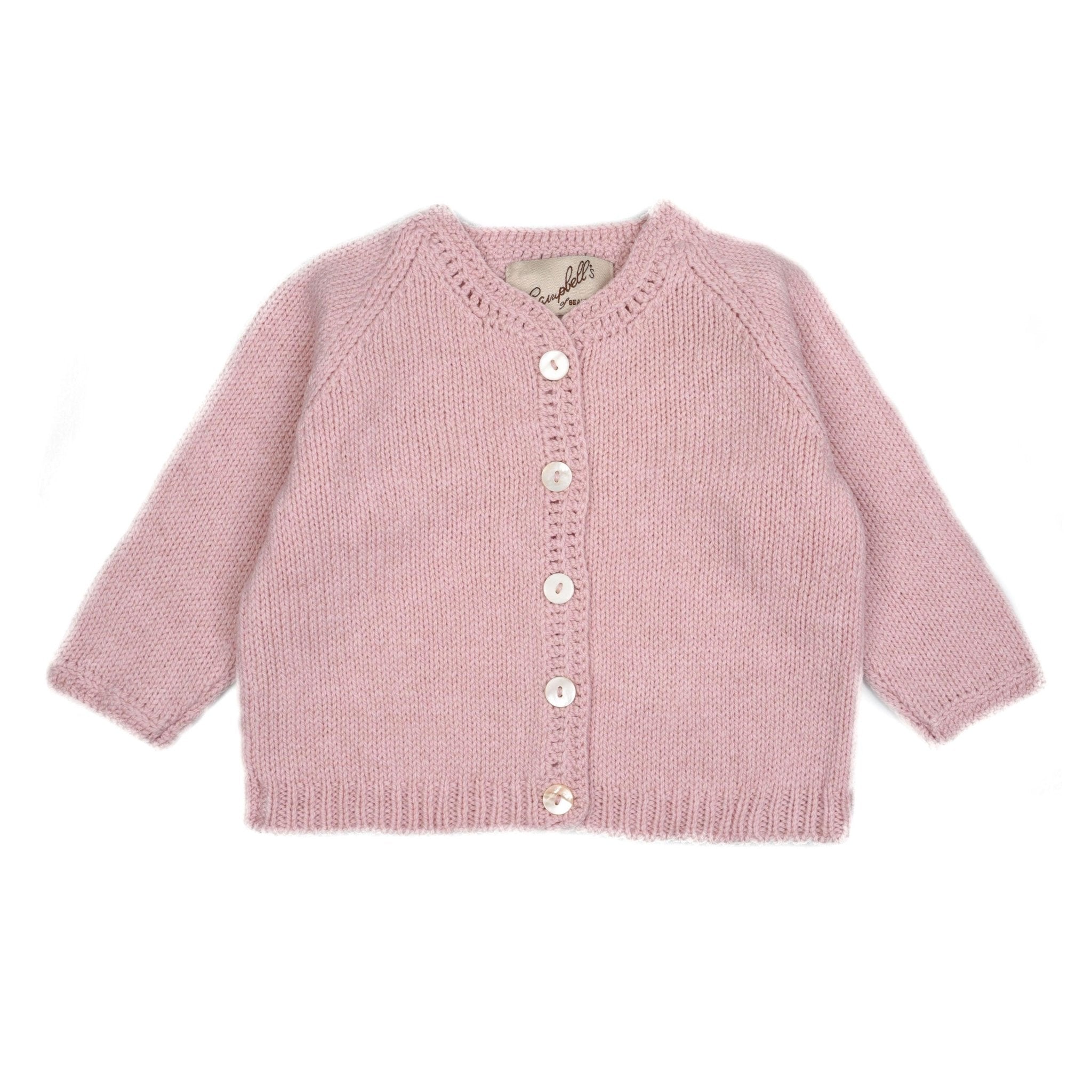 The Campbells of Beauly Baby Cardigan is a soft pink lambswool piece with long sleeves and five white front buttons, hand-knitted for classic layering. Shown laid flat on a white background.