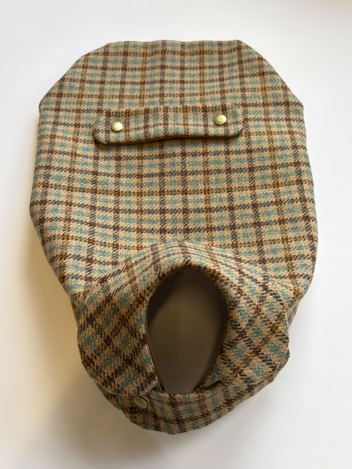 A House Tweed Dog Coat M by Campbell's of Beauly in a brown, green, and tan plaid pattern, featuring a small flap and two buttons, is displayed flat on a white surface.