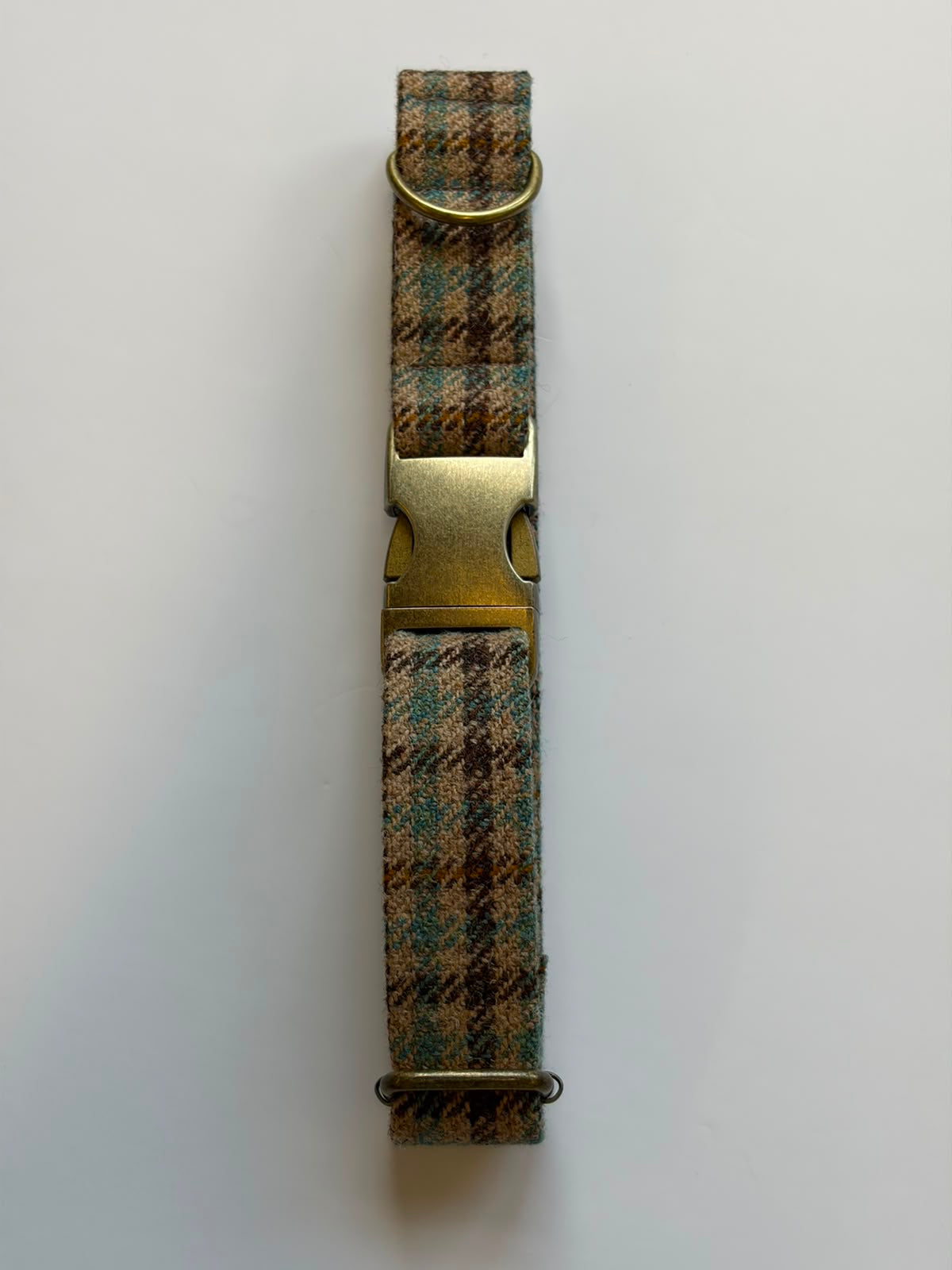 House Tweed Dog Collar by Campbell's of Beauly, featuring plaid fabric and brass-colored buckle and D-rings, laid flat on a white background.