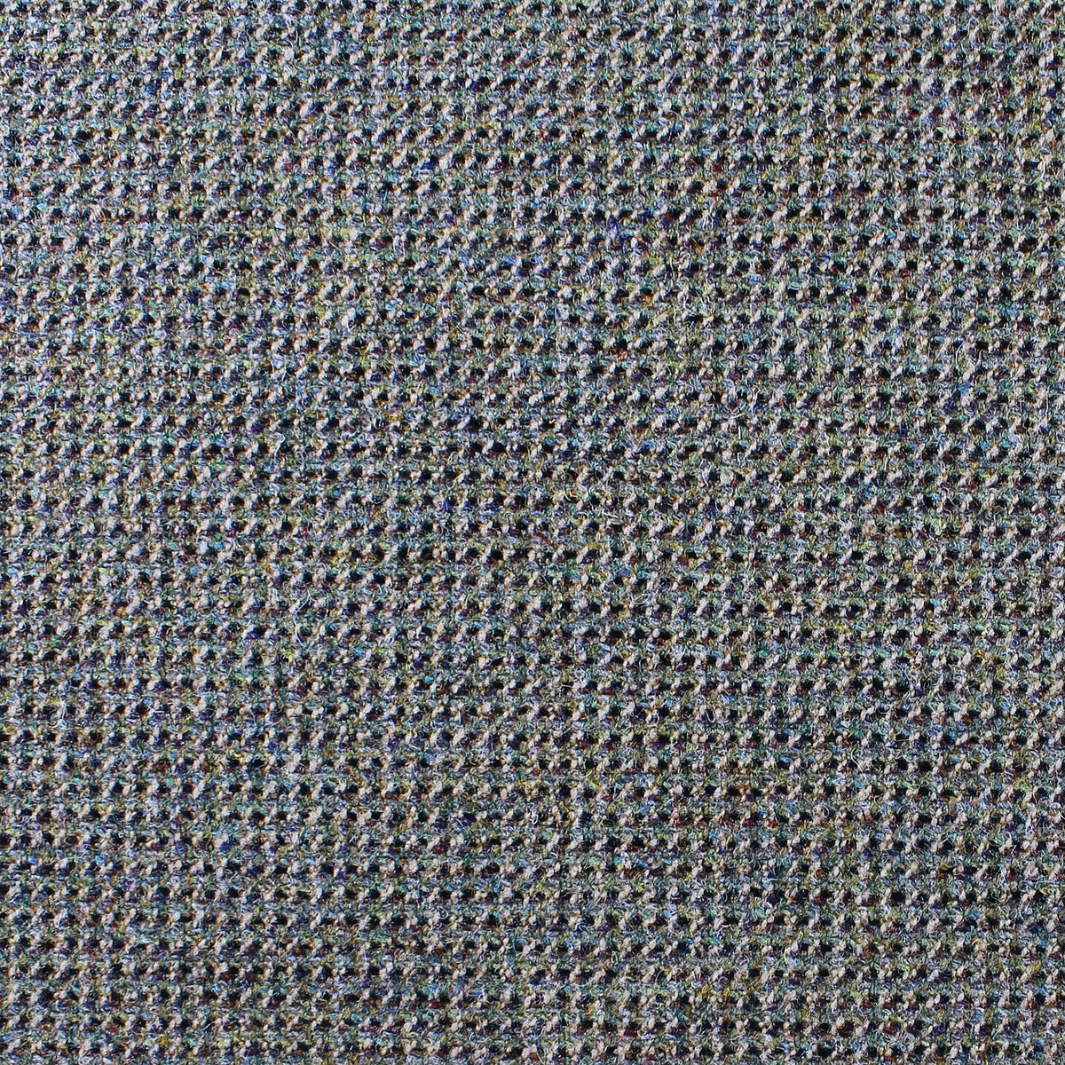 Close-up of Lovat Mill Estate Tweed 038, a tightly woven estate weight tweed with a textured, speckled pattern in shades of blue, gray, and brown.